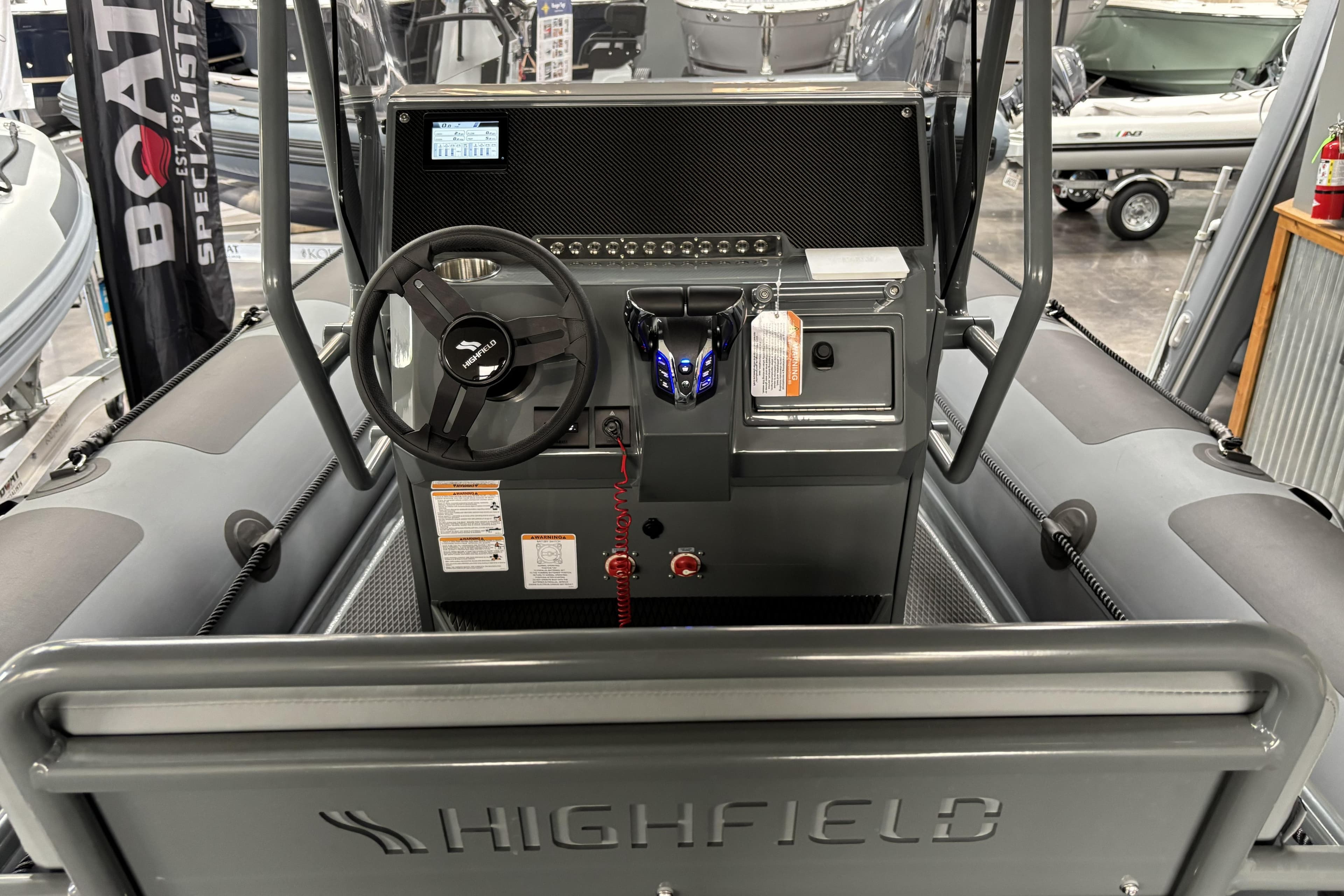 Interior view of 2026 Highfield Patrol 760 boat console with steering wheel and controls.