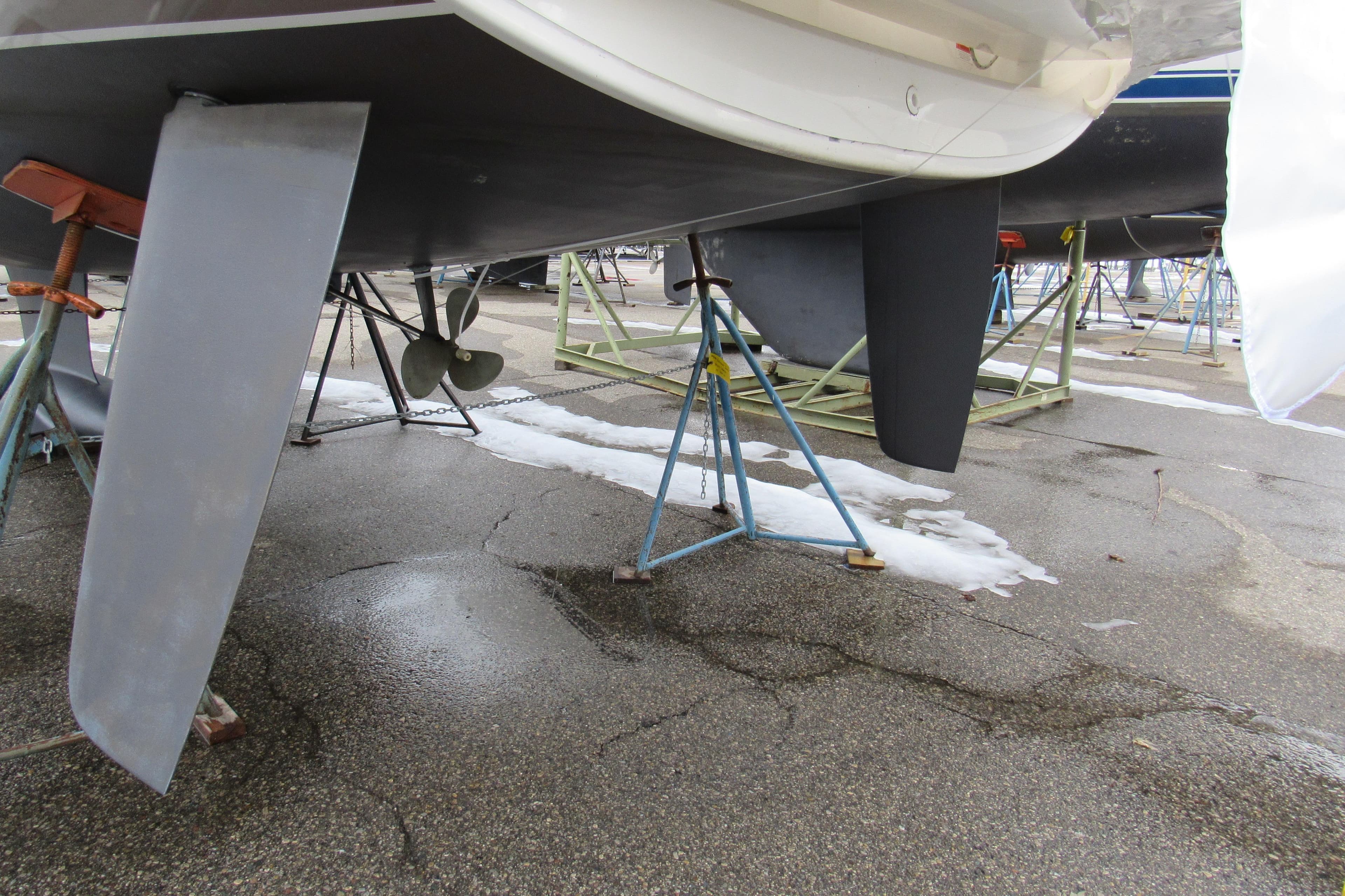 2023 Jeanneau Sun Odyssey 349 sailboat on stands, showing keel and propeller.