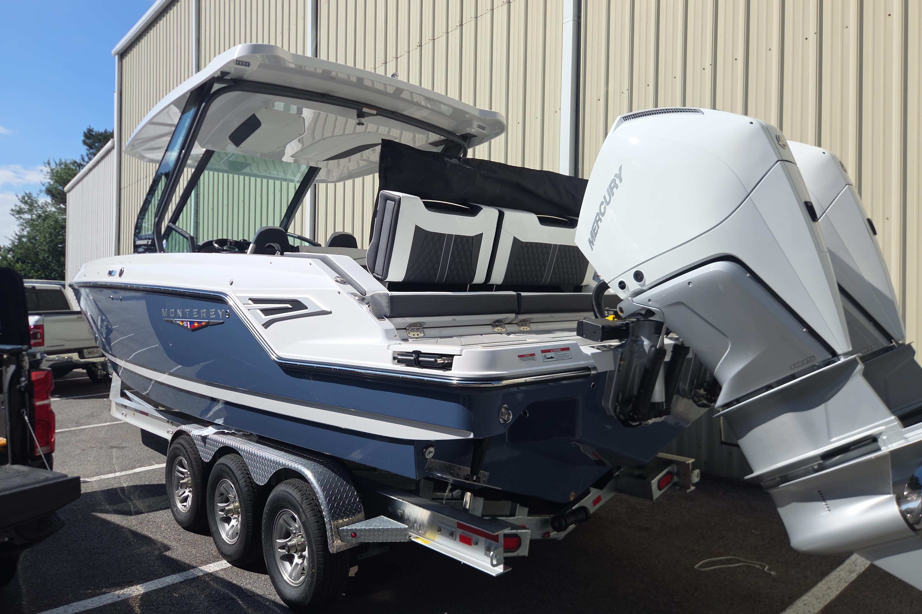 2026 Monterey Elite 30 OB boat with dual Mercury outboard engines on a trailer.