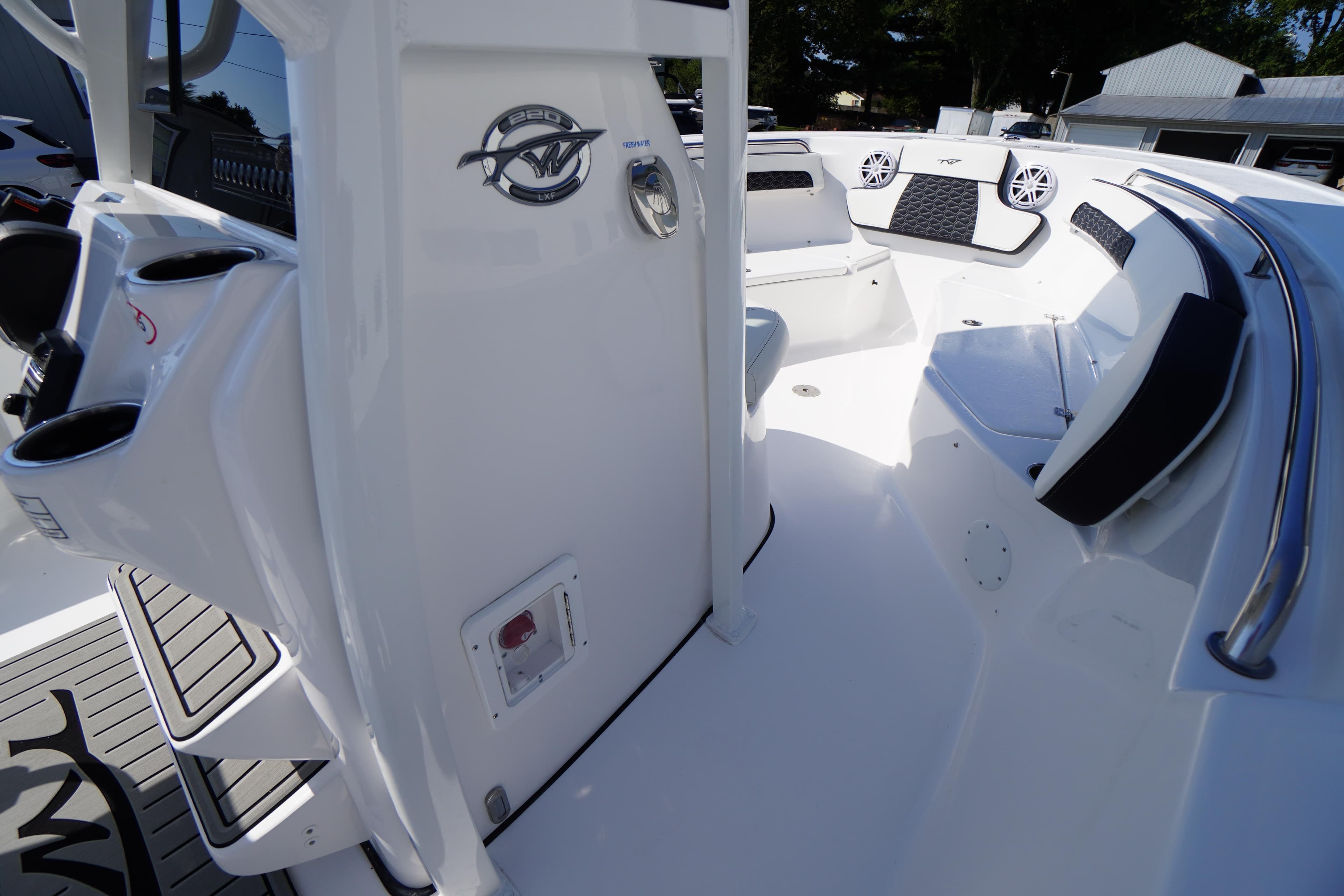 2026 Tidewater 220 LXF boat interior with seating and cup holders.
