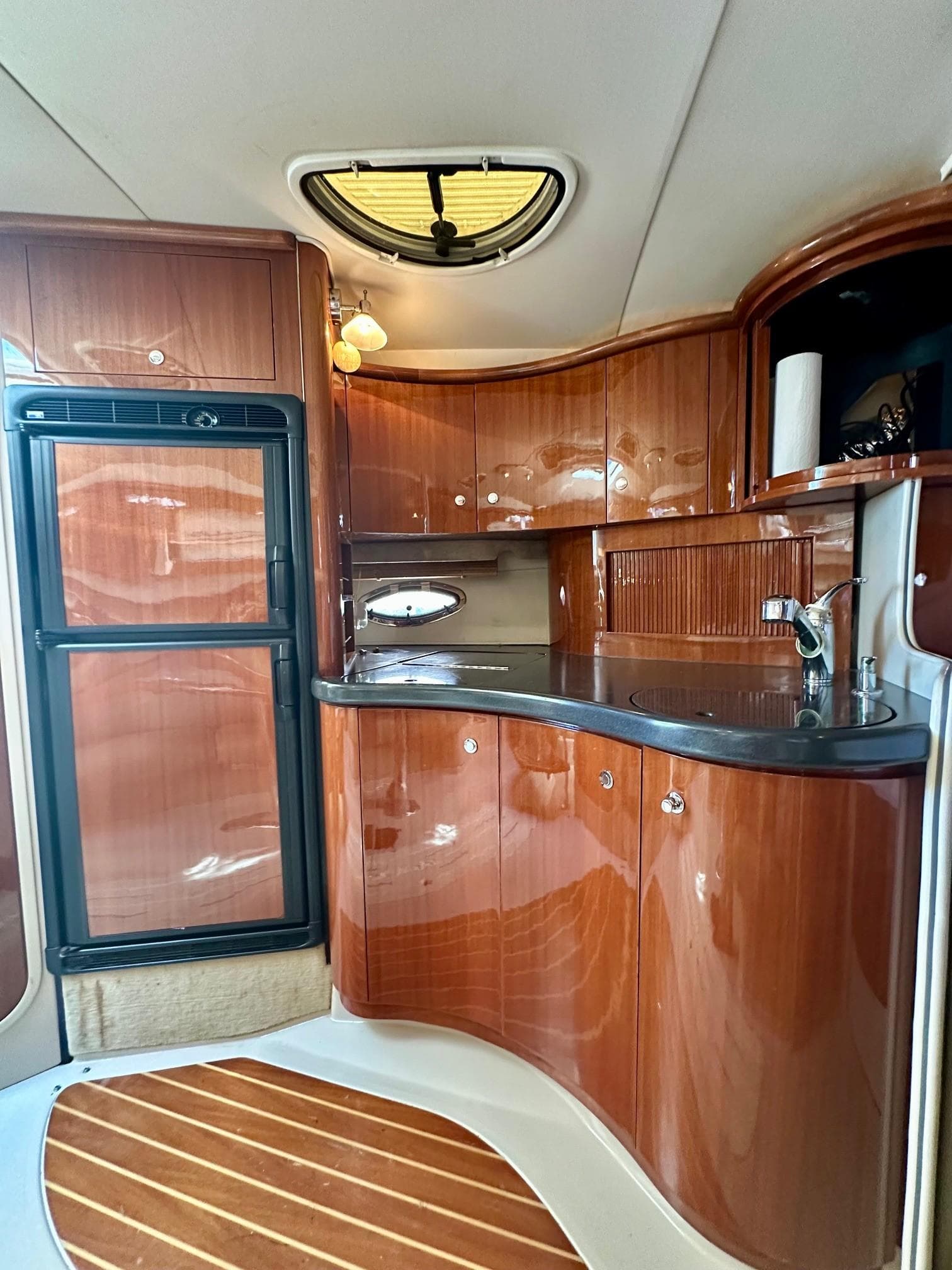 Luxurious 2005 Doral Boca Grande yacht interior with sleek wooden cabinetry and modern amenities.