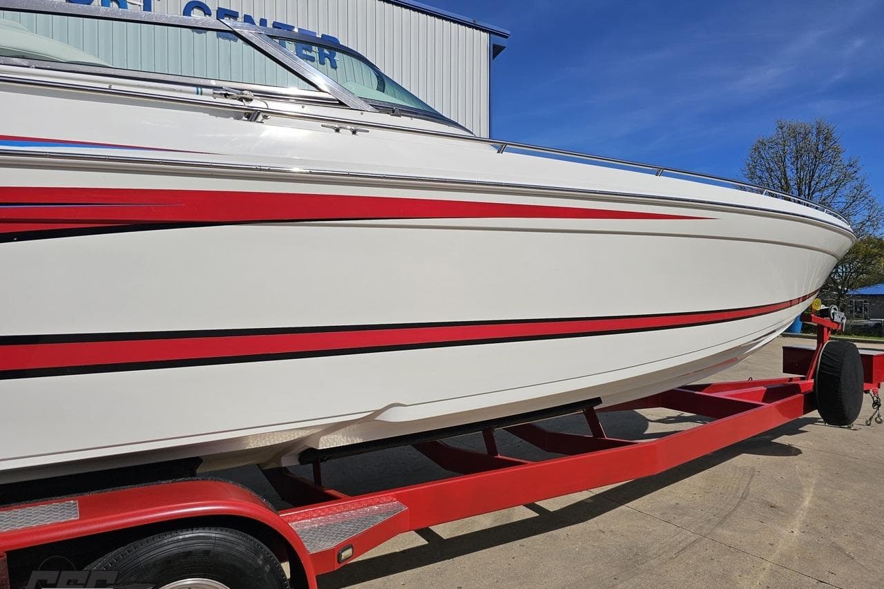 2001 Formula 382 FASTech boat on red trailer, white with red stripes.