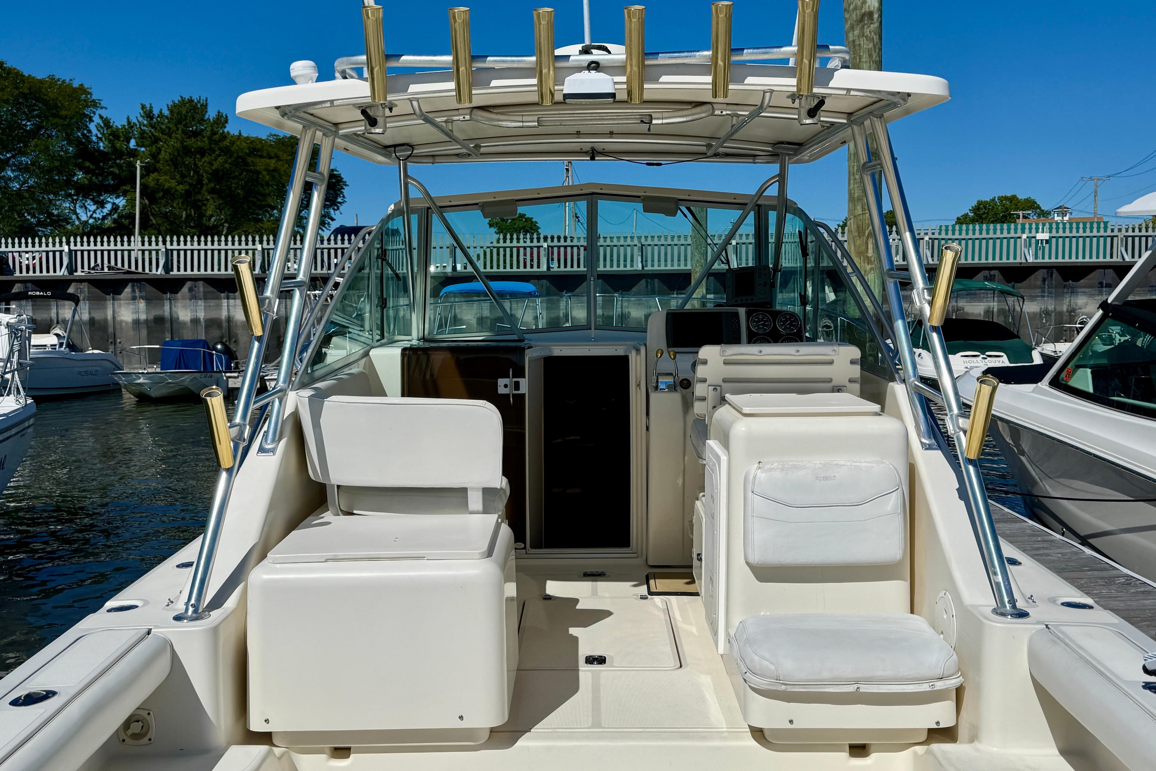 2000 Pursuit 3000 Express boat interior with seating and helm, docked in marina.
