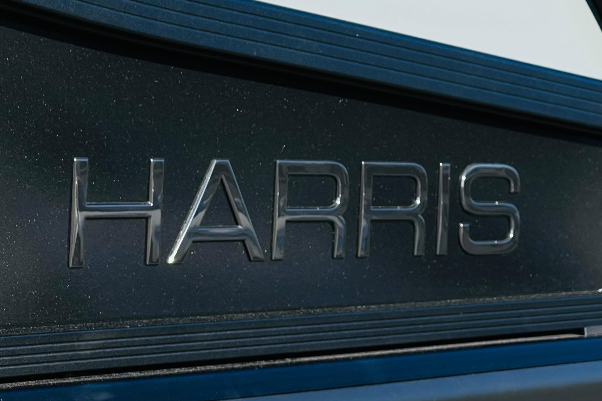 Close-up of "HARRIS" logo on 2026 Harris Grand Mariner 230 boat.