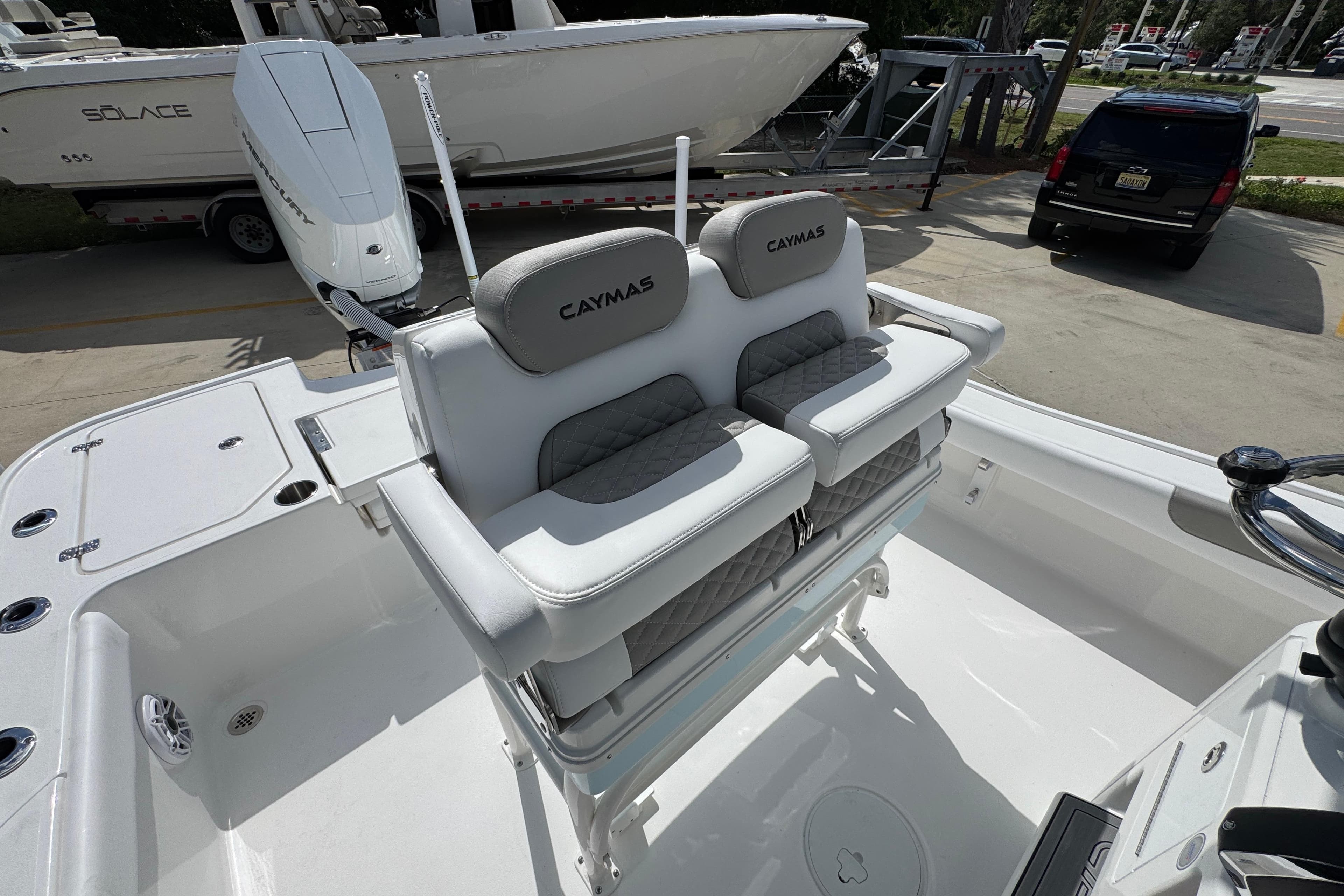 2026 Caymas 26 HB boat interior with dual seats and Mercury engine.