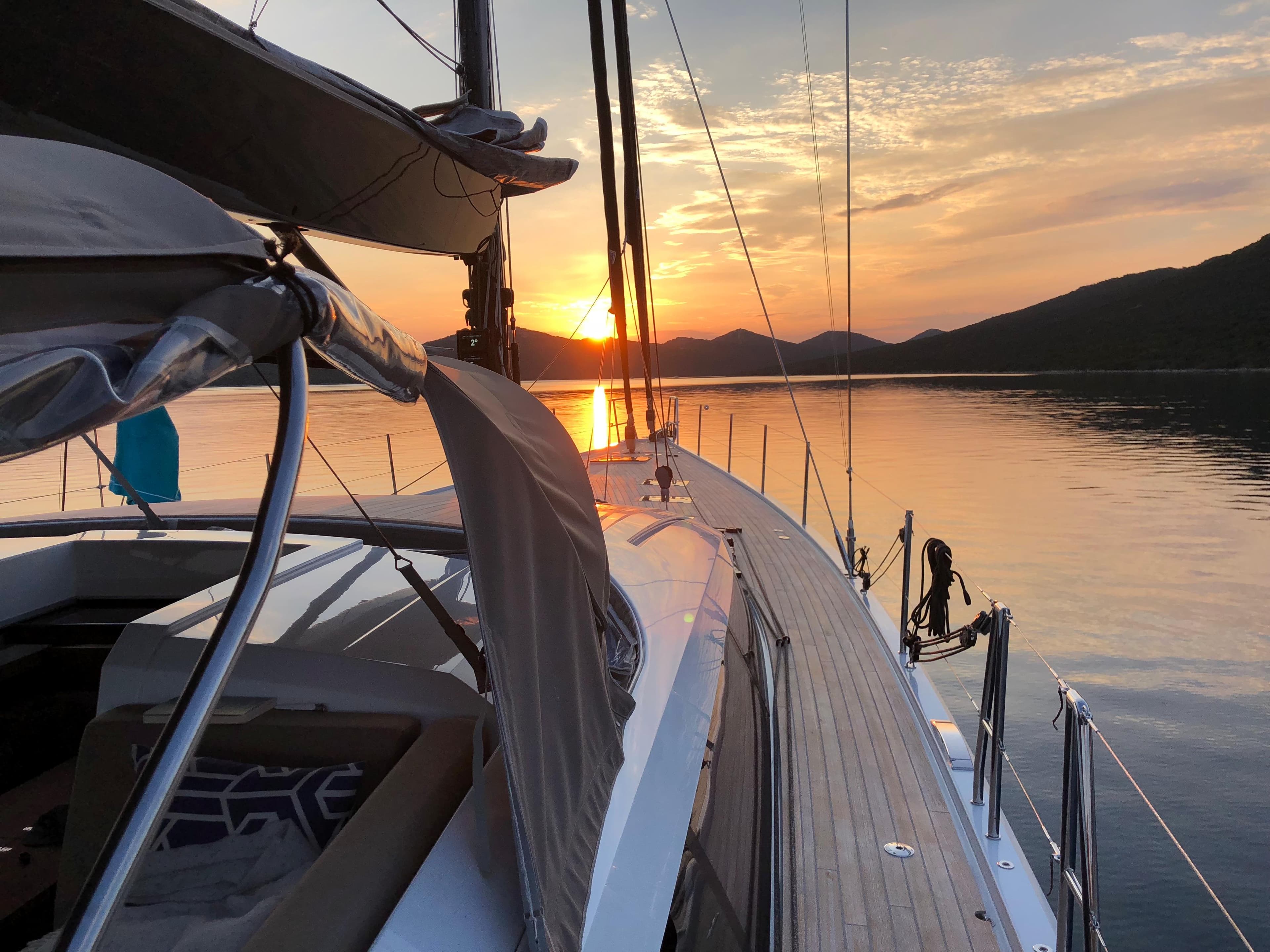 Sailing yacht CNB 76 at sunset, calm waters, 2017 model.