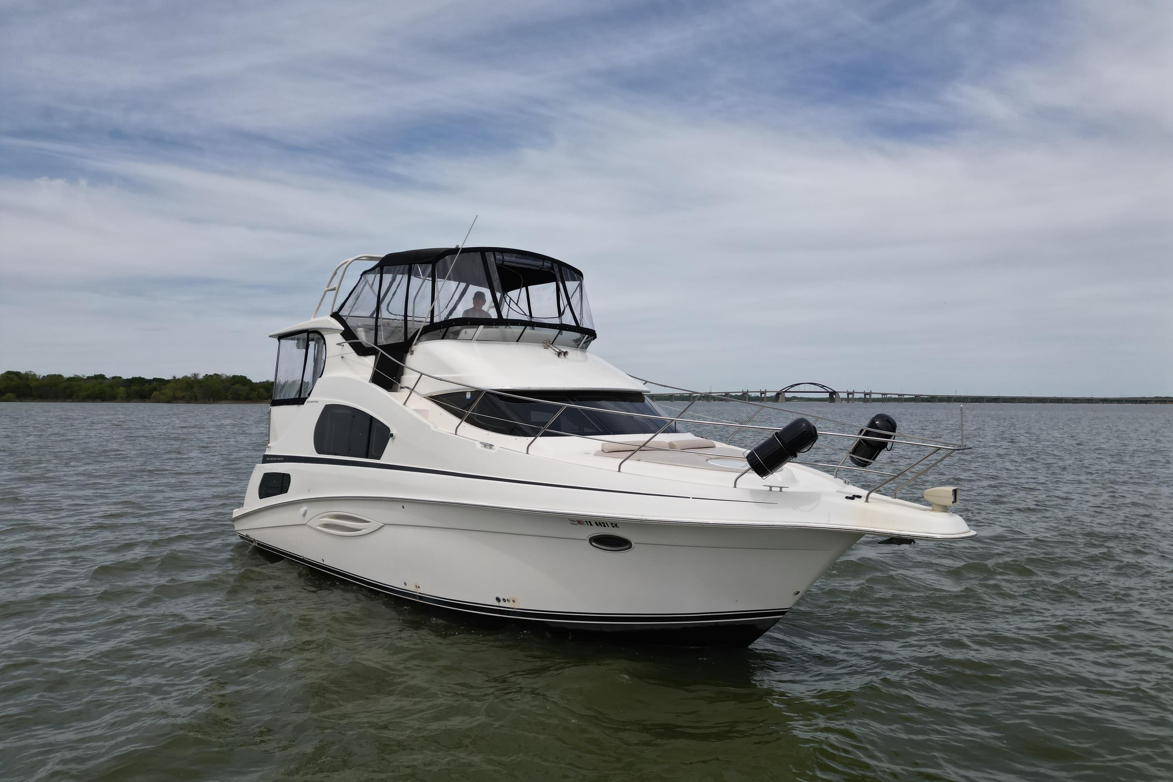 2003 Silverton 39 Motor Yacht on calm water under a cloudy sky.