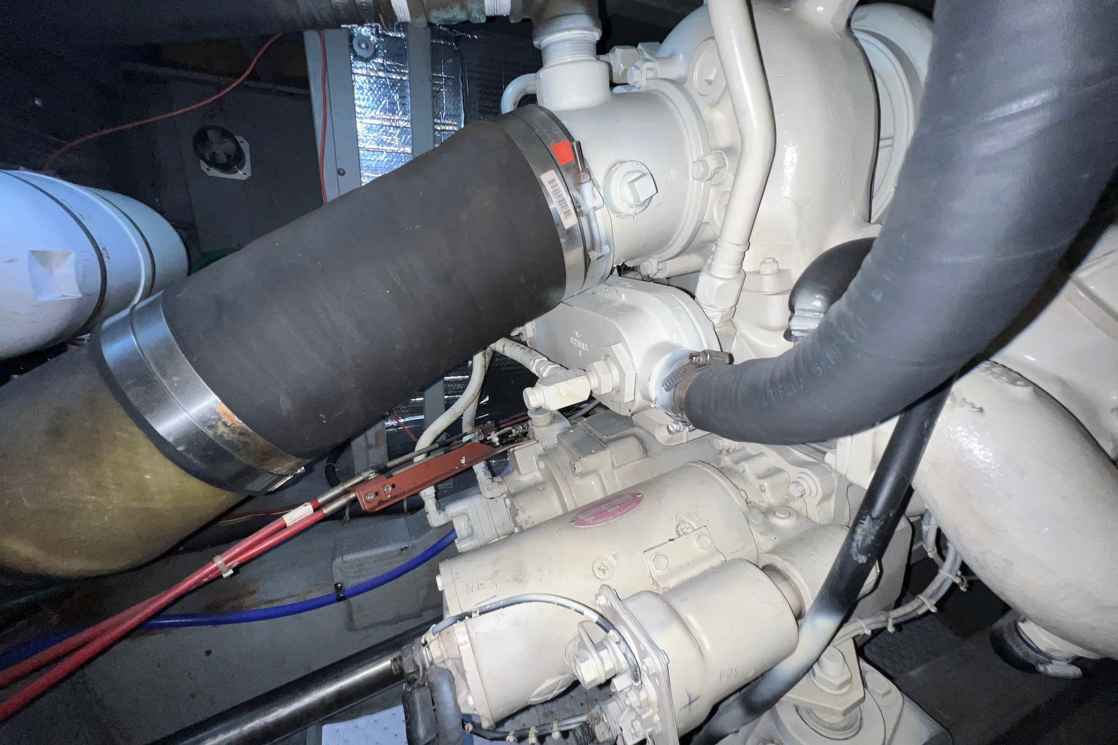 Engine compartment of a 1985 Tollycraft 48 Cockpit Motor Yacht, showcasing mechanical components.