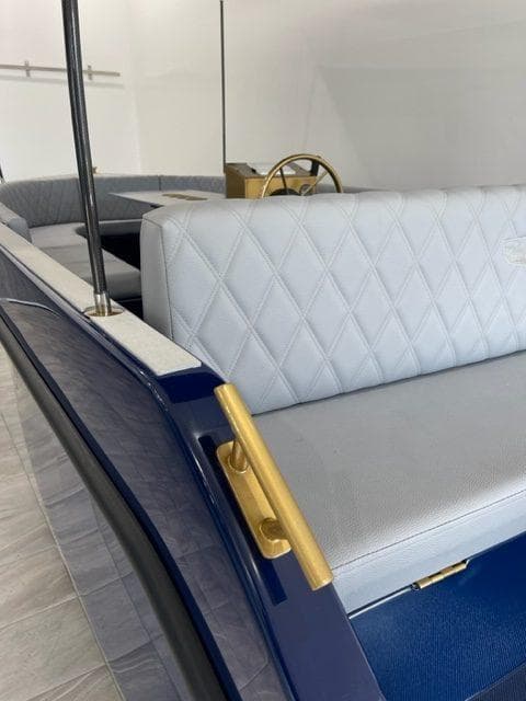 2023 Vision Marine Technologies Volt 180 boat interior with elegant seating and gold accents.