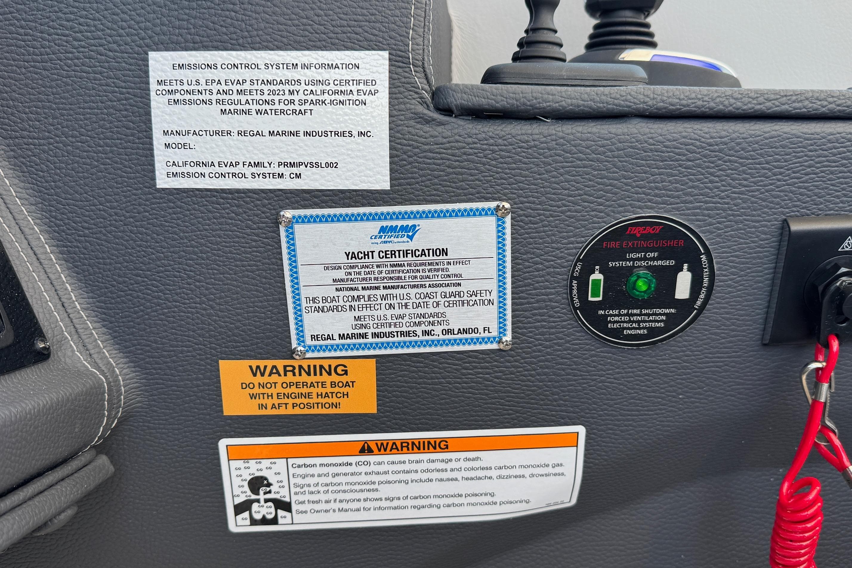 Control panel of 2026 Regal 33 XO yacht with safety and certification labels.