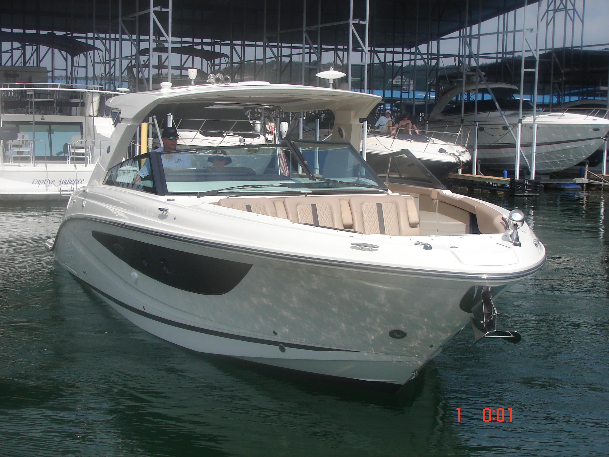 2018 Sea Ray SLX 400 boat docked in marina, featuring sleek design and spacious seating.