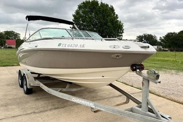 2007 Chaparral 204 SSi boat on trailer, parked outdoors on a cloudy day.