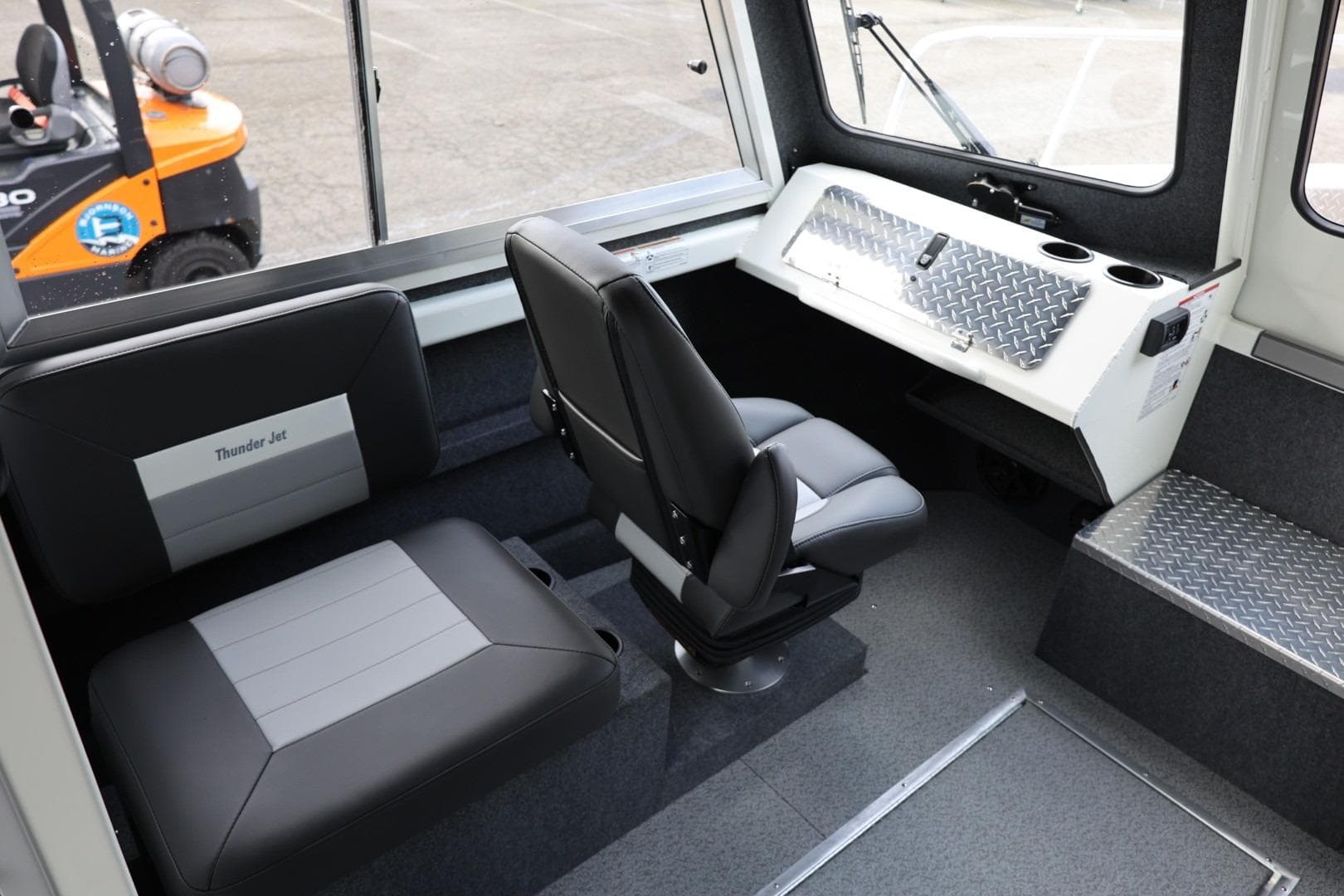 Interior of 2026 Thunder Jet 26 Alexis Pro XL boat with seating and control panel.