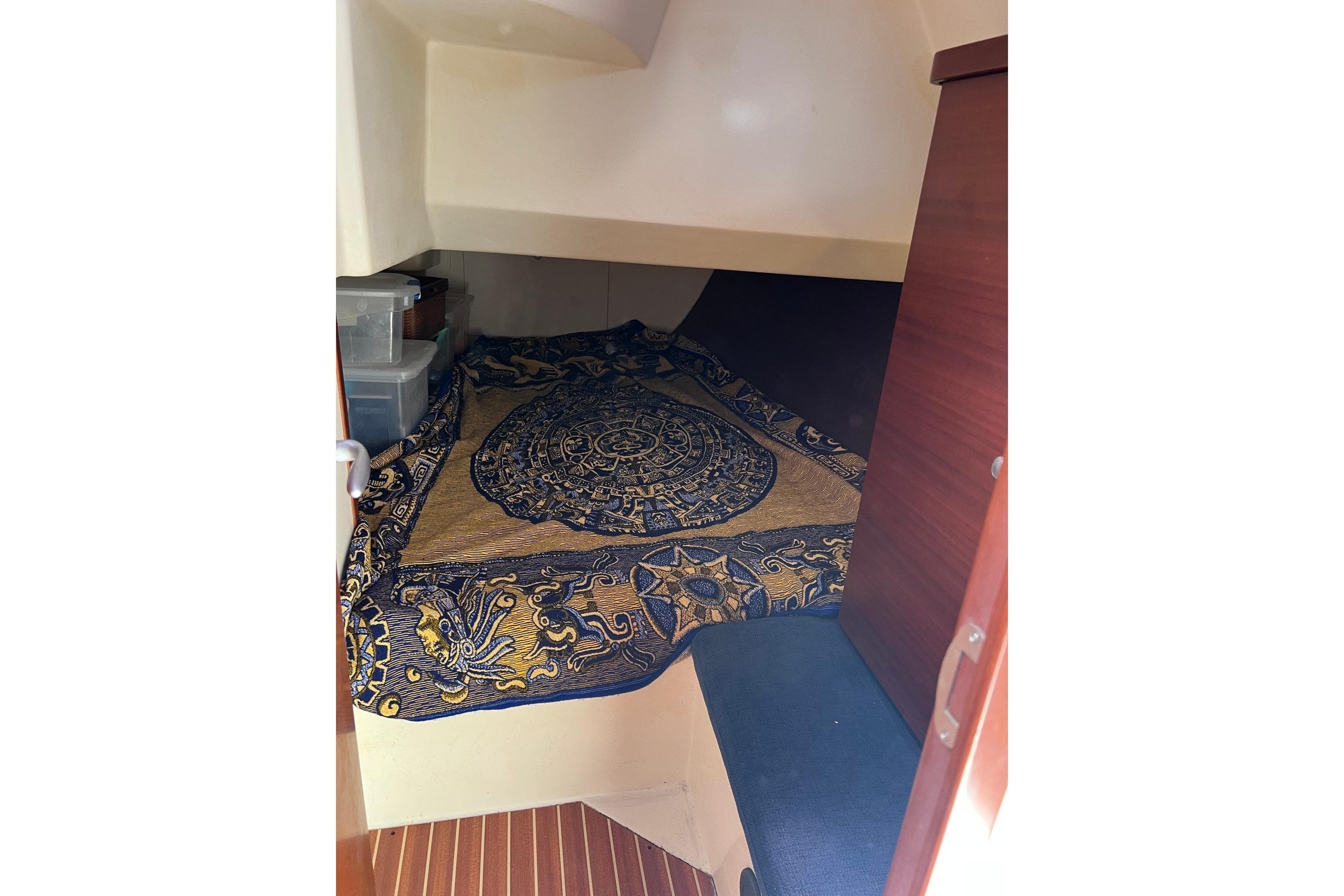 Cozy cabin interior of 2007 Hanse 400e sailboat with decorative bedding.