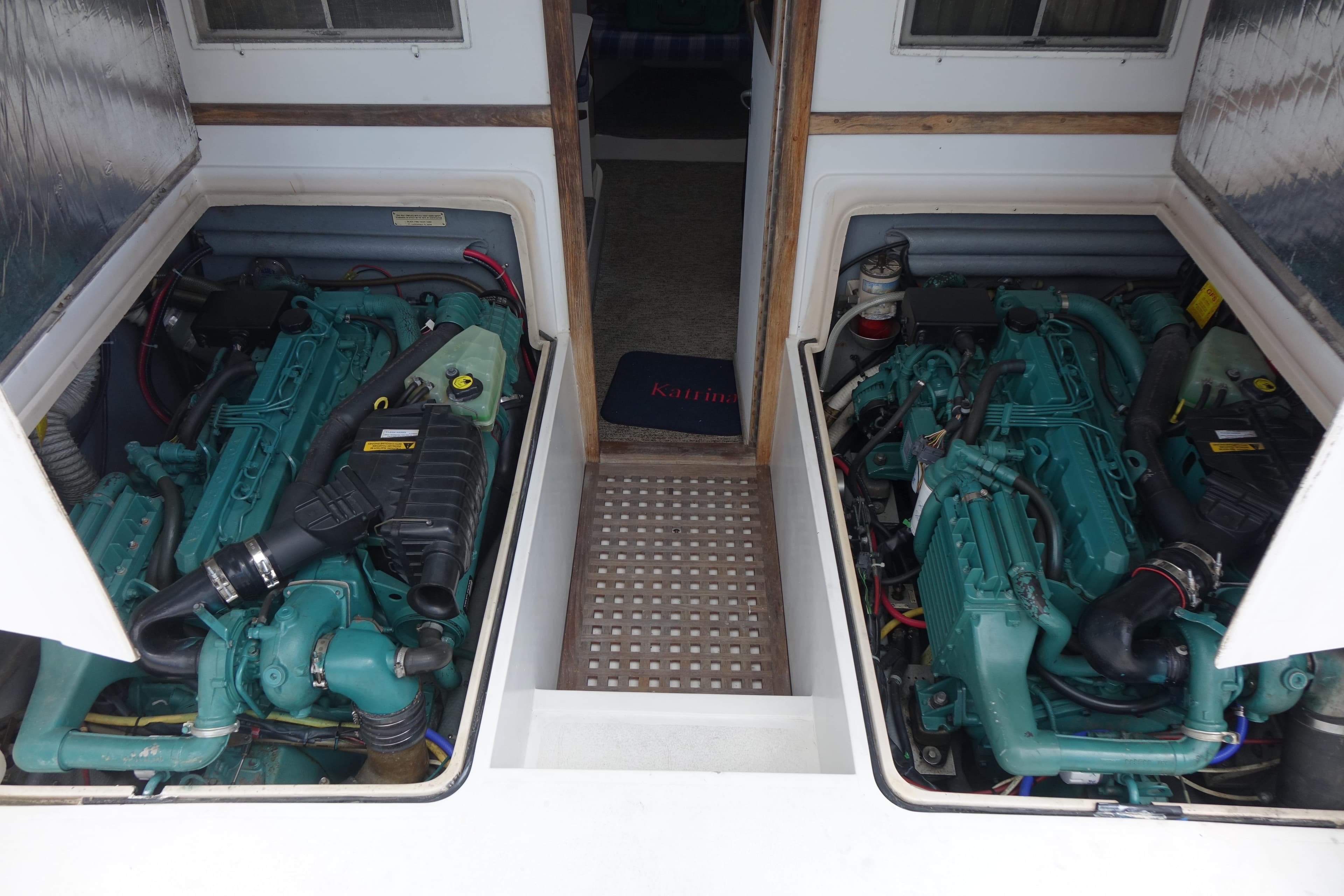 Twin engines in a 1988 Blackfin 29 Flybridge boat, showcasing engine compartment details.