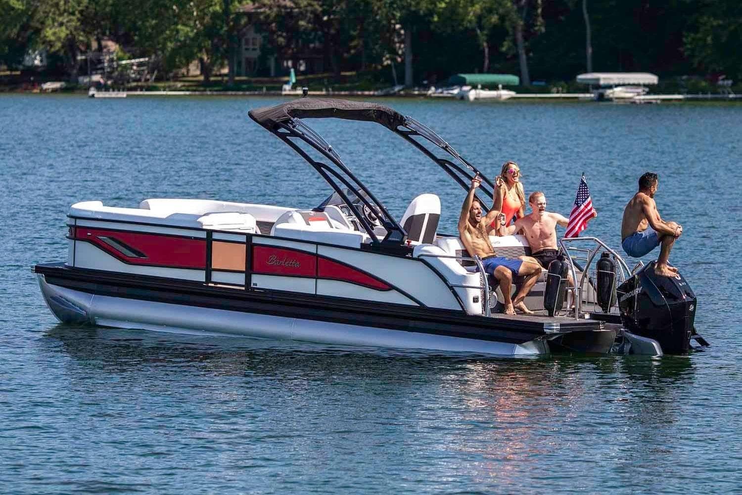2026 Barletta Corsa 23UA pontoon boat on a lake with passengers enjoying the ride.