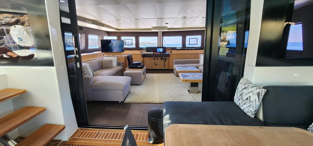 Luxurious interior of 2017 Lagoon 620 Essence yacht with modern seating and panoramic windows.