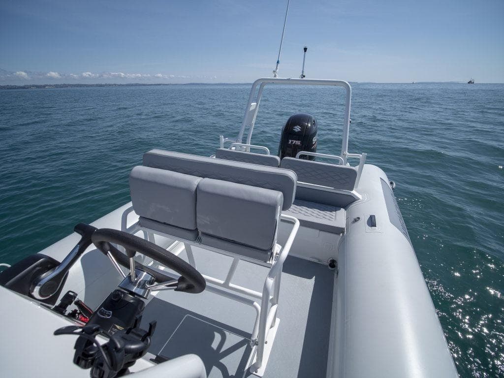 2024 Highfield Patrol 600 boat on open water, featuring sleek design and modern seating.