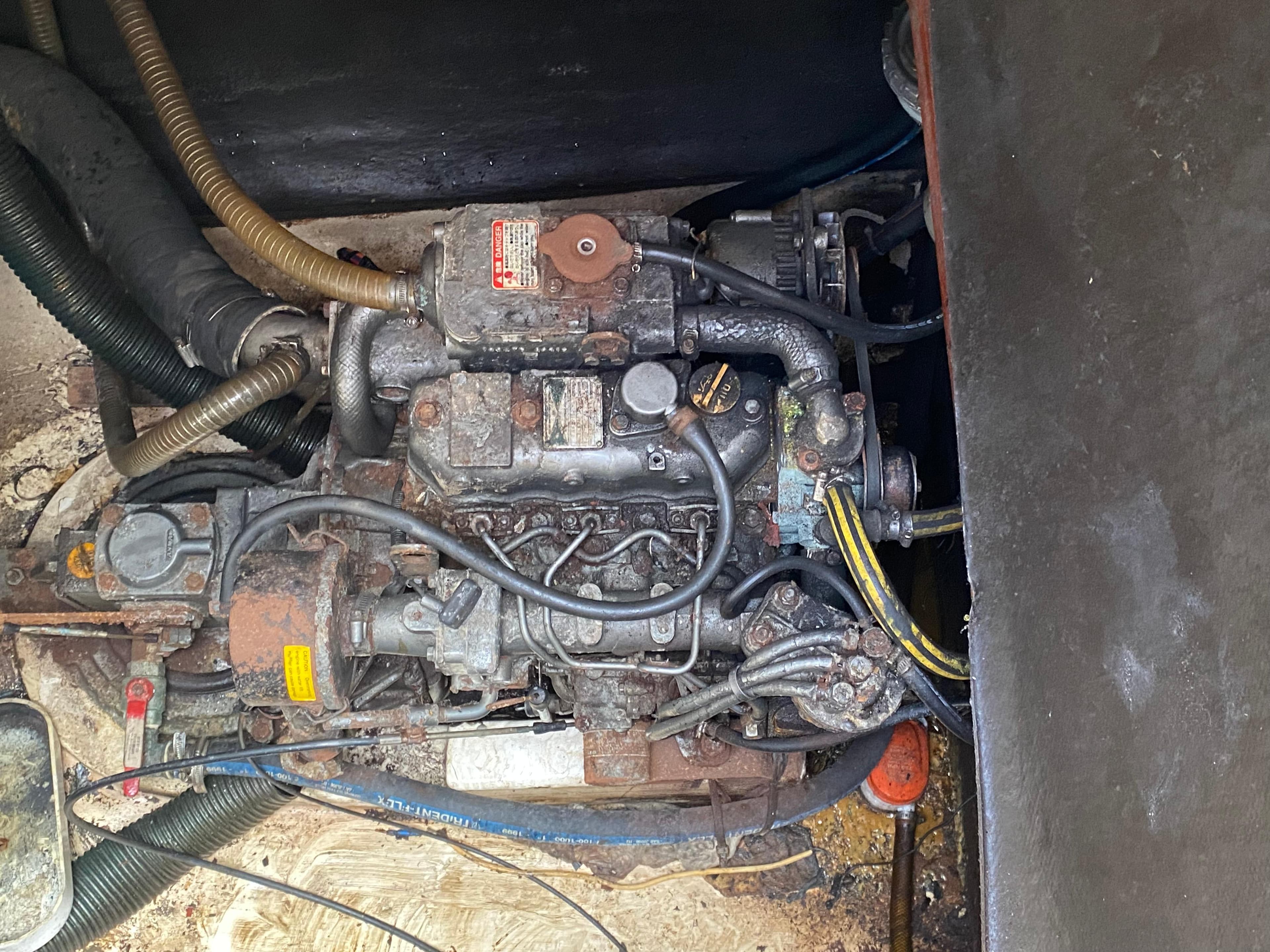 Engine compartment of a 1998 Fountaine Pajot Bahia 46 catamaran, showing mechanical components and hoses.