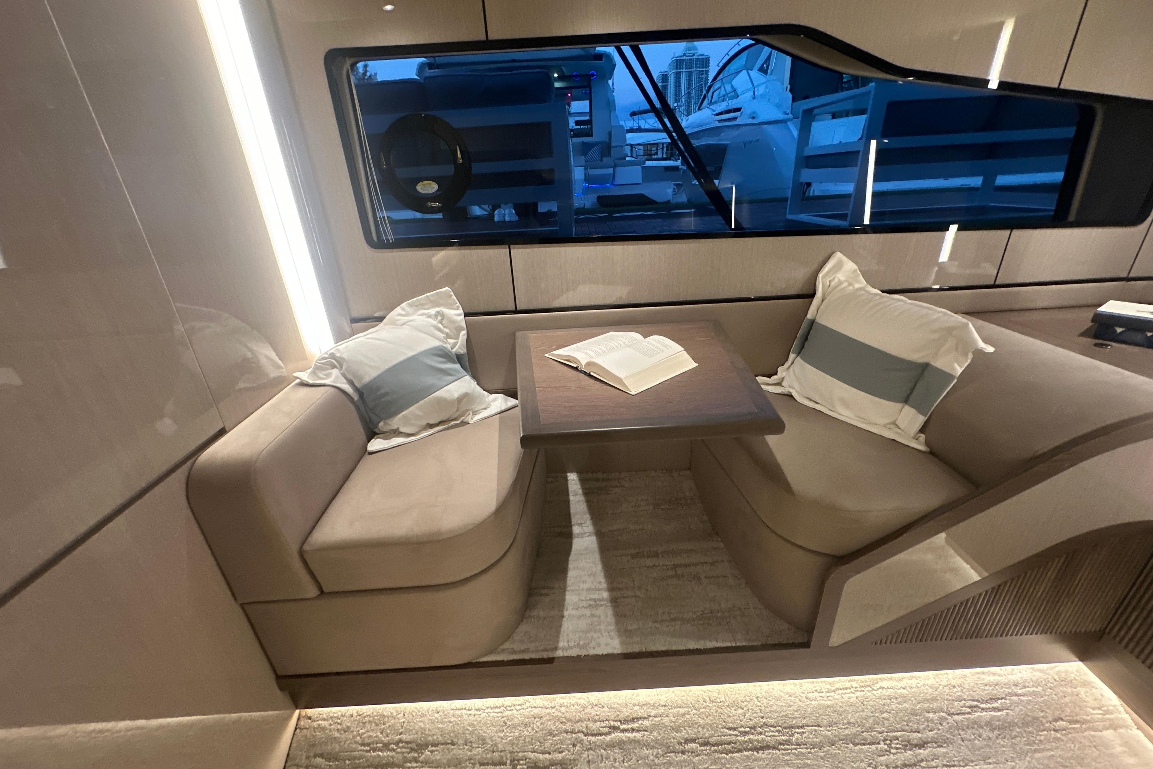 Luxurious interior of 2026 Cruisers Yachts 57 Fly with cozy seating and open book.