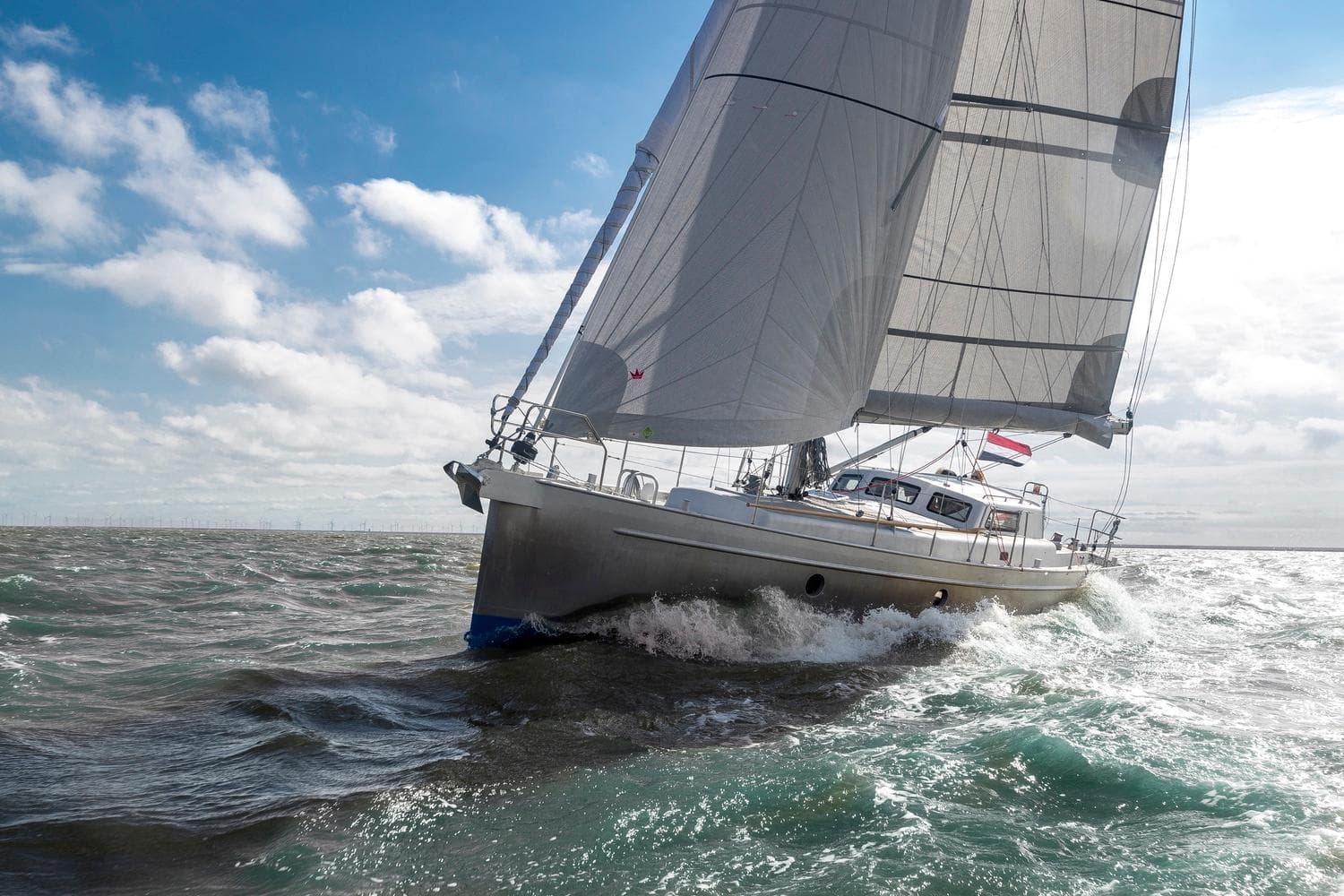 Sailing yacht Bestevaer 36, 2023 model, navigating through ocean waves under a clear sky.