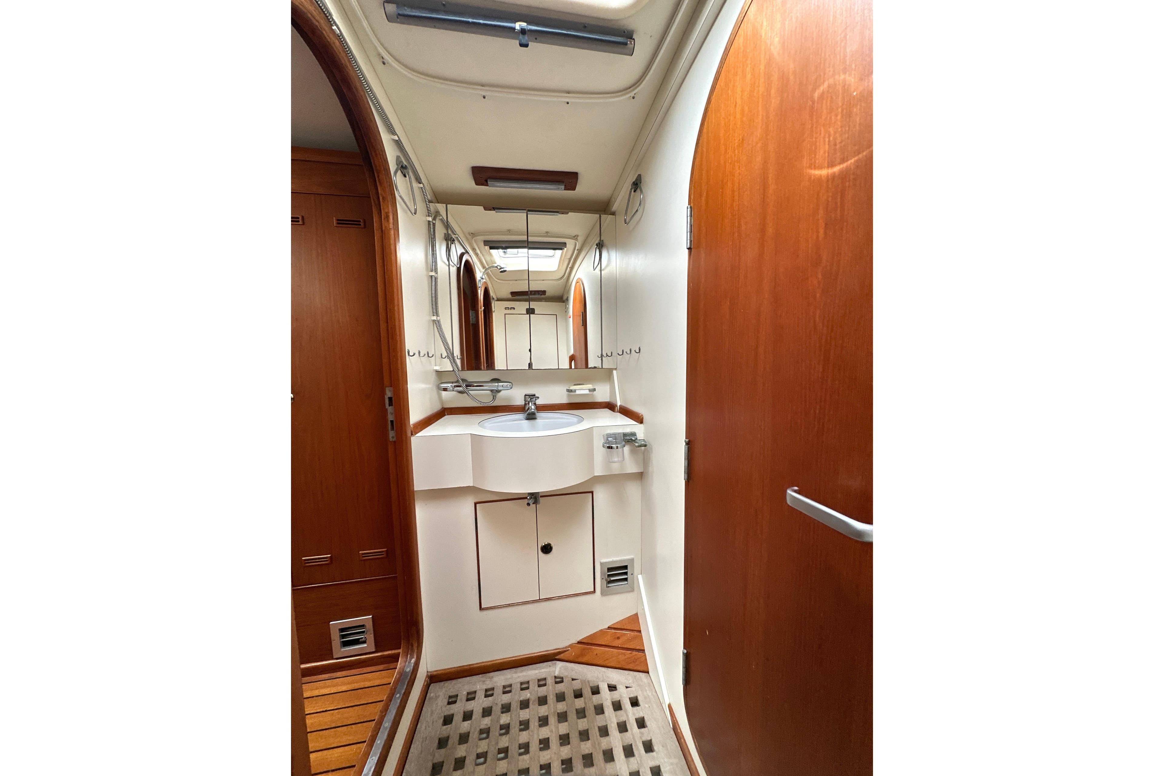 Interior of 1991 Standfast 56 yacht bathroom with wooden doors and modern sink.