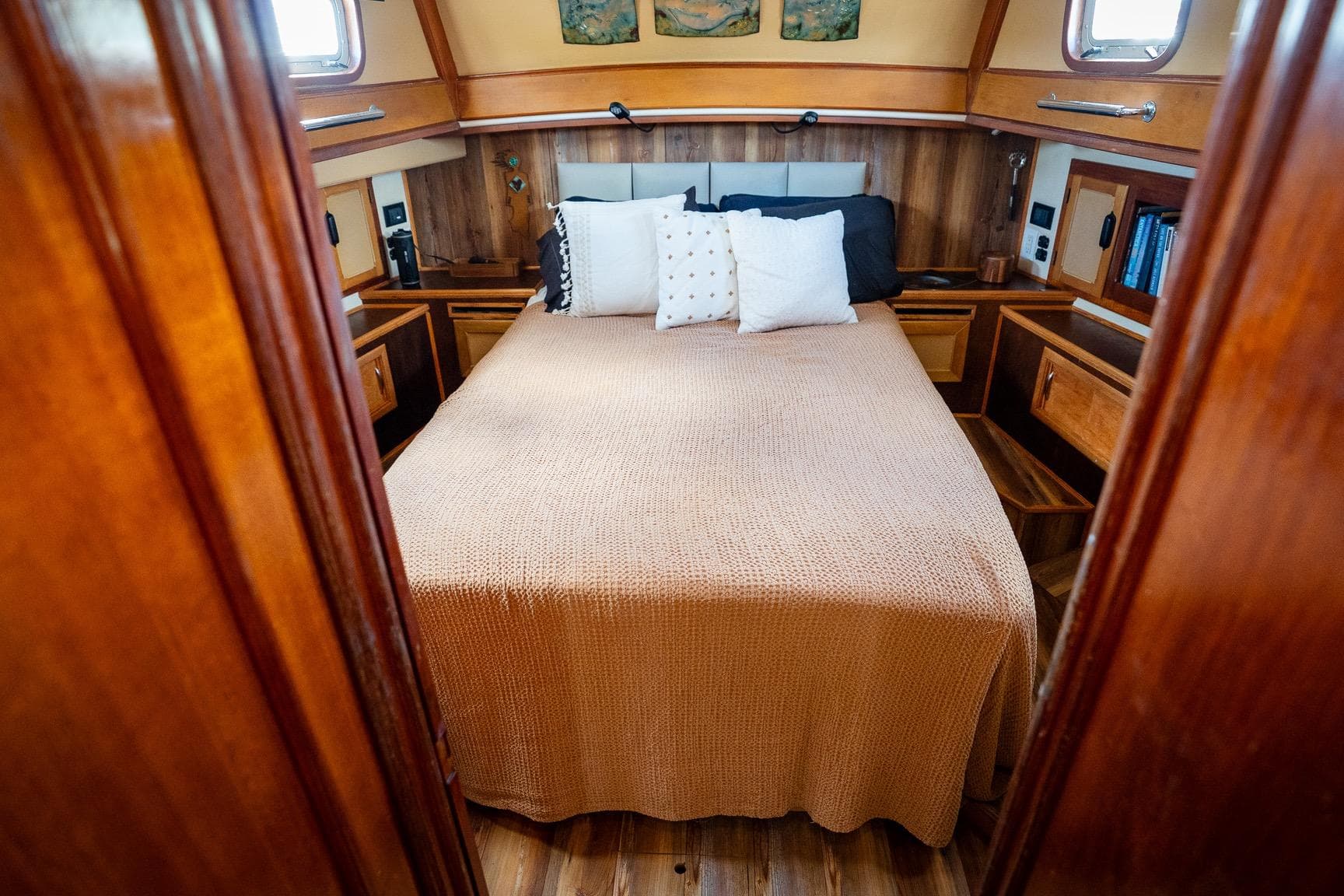 Cozy cabin bedroom in 1973 Alan Wright Custom 65 yacht with wooden interior.