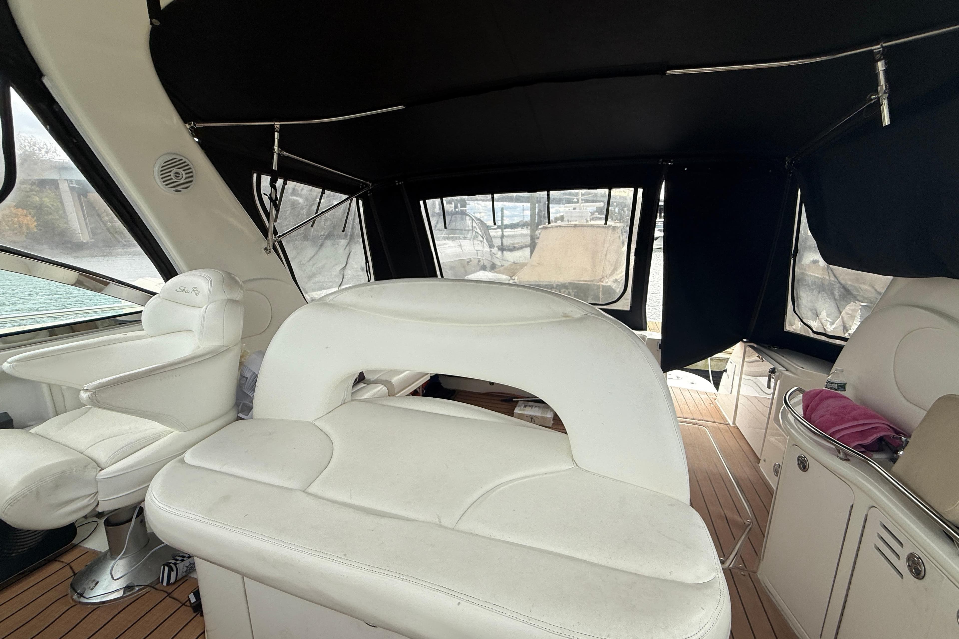 Interior of 2001 Sea Ray 410 Sundancer with white seating and wood flooring.