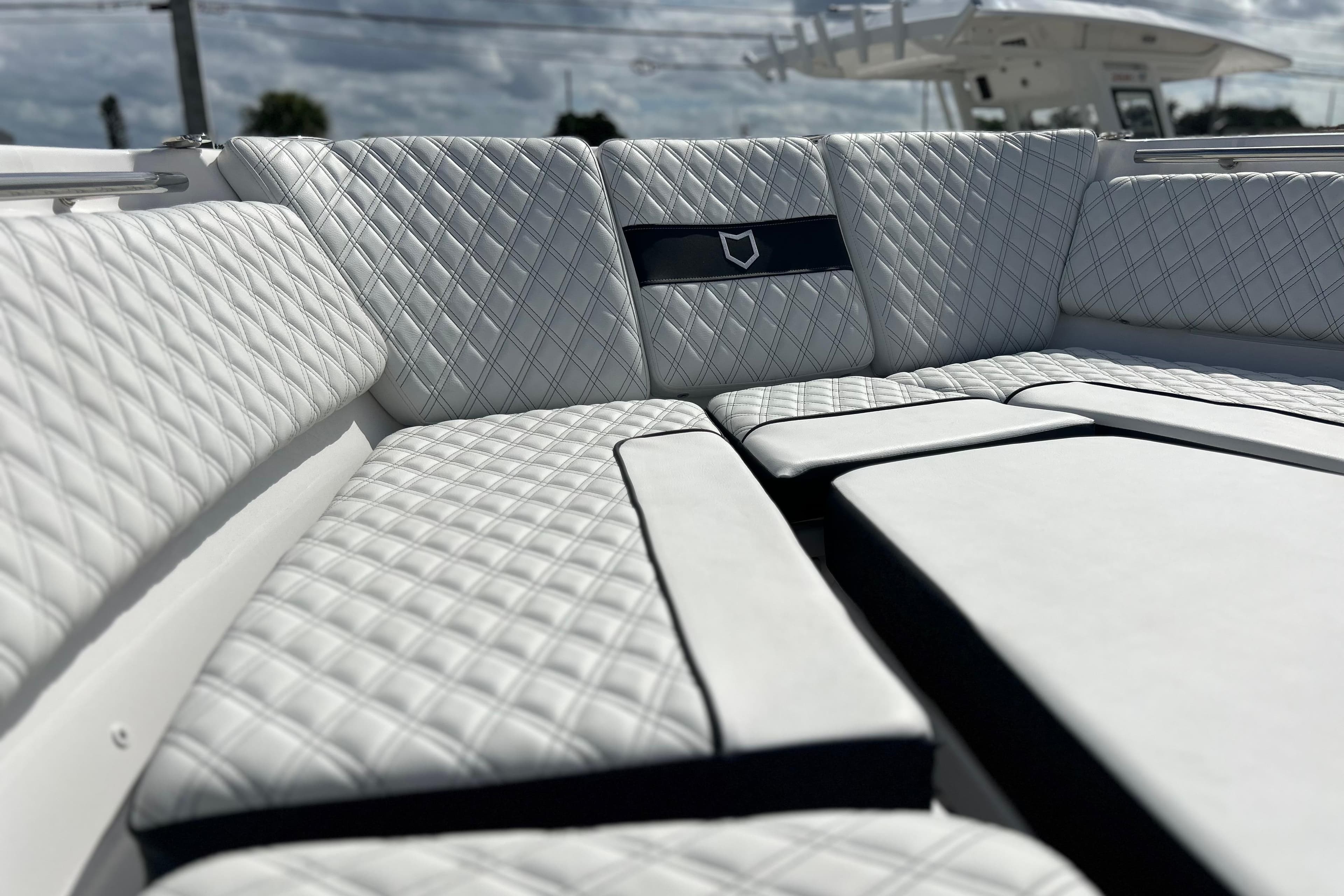 Luxurious seating on 2026 Sea Fox 368 Commander boat with quilted white upholstery.