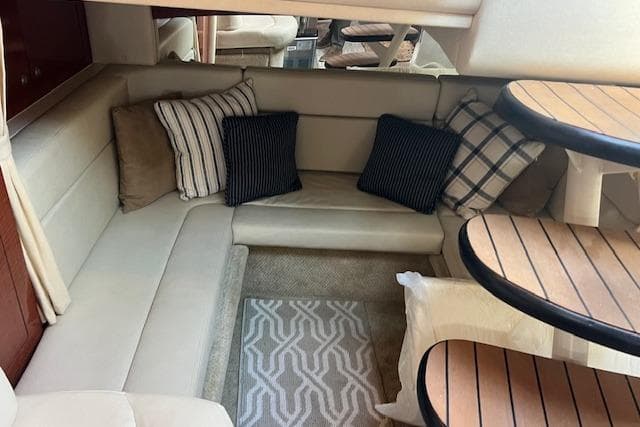 Interior of 2005 Searay 320 boat with cozy seating and decorative pillows.