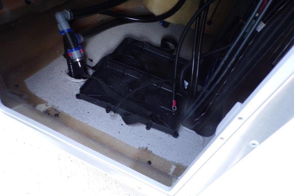 Interior view of 2026 Xpress H20B Bay boat compartment with wiring and plumbing.