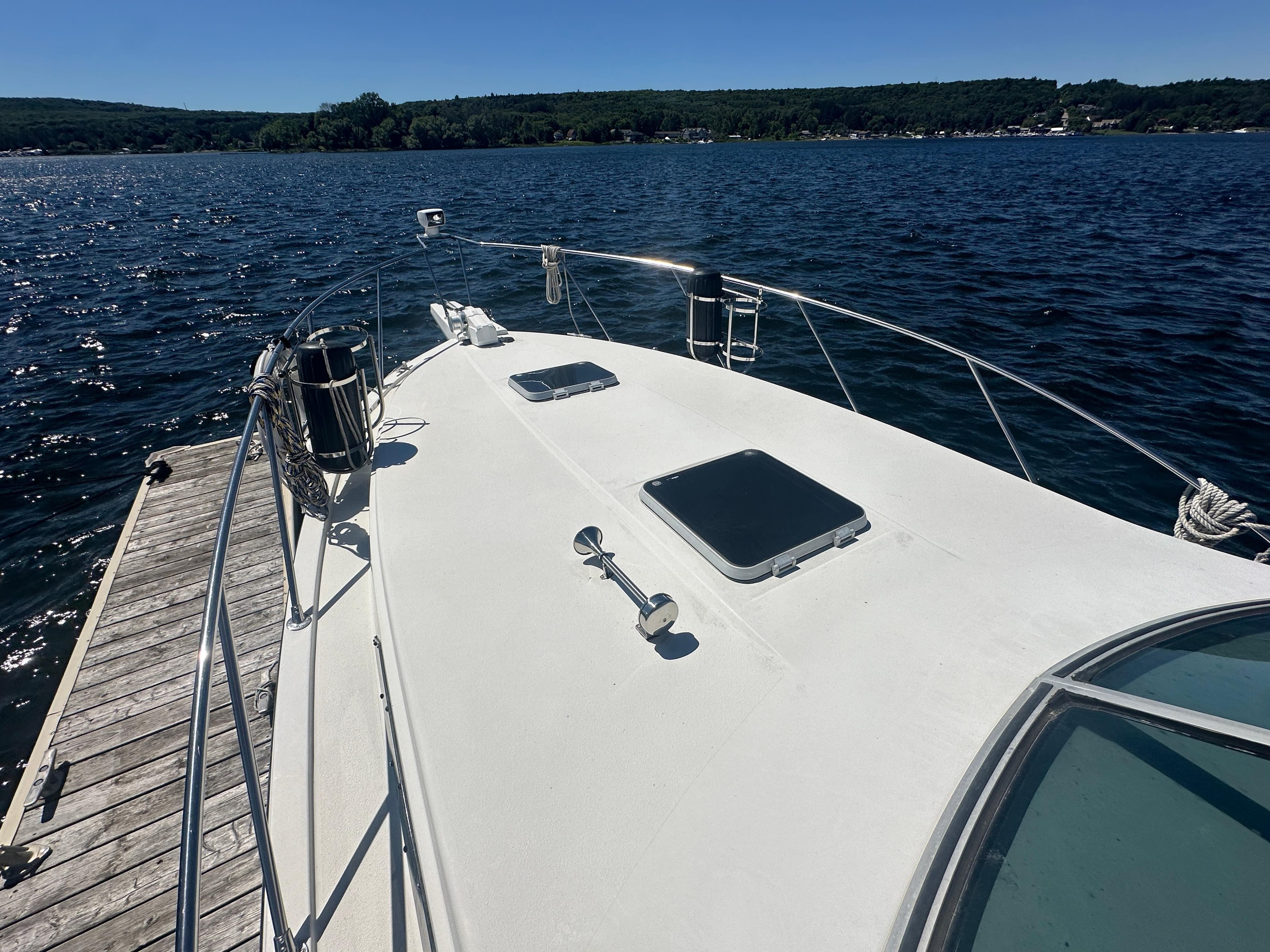 1988 Chris-Craft 284 Amerosport boat docked on a sunny lake.