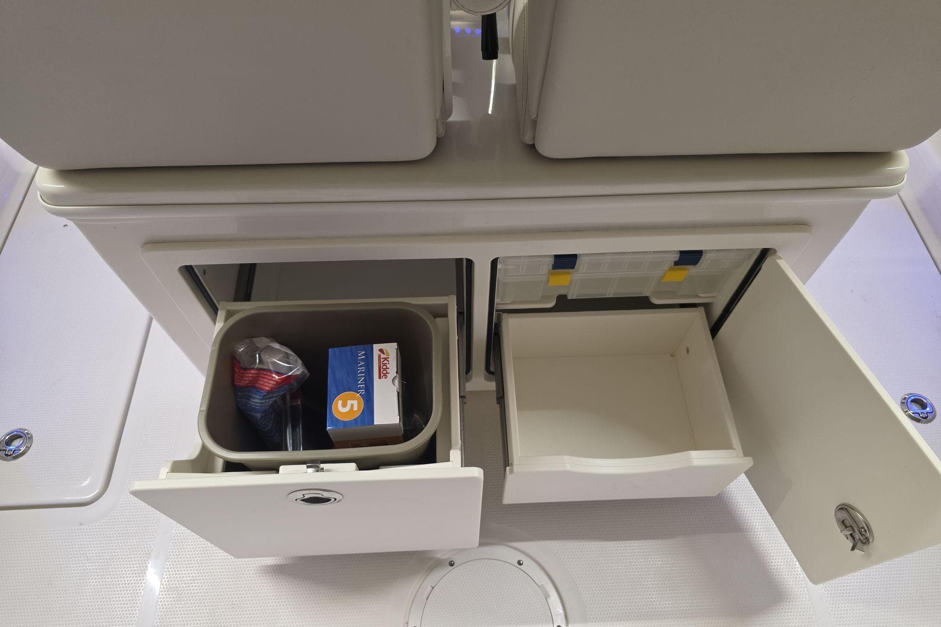 Storage compartments on a 2026 Sailfish 252 CC boat, featuring organized drawers and containers.