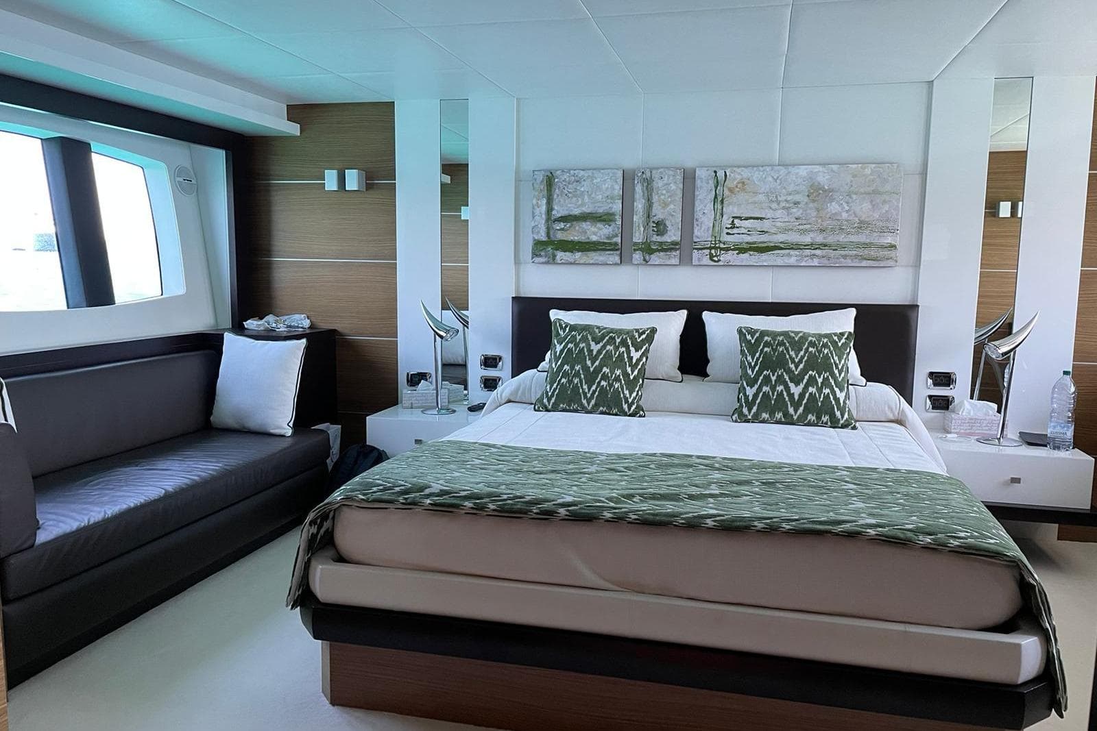 Luxurious bedroom interior of 2008 Astondoa 76 GLX yacht with modern decor and large window.