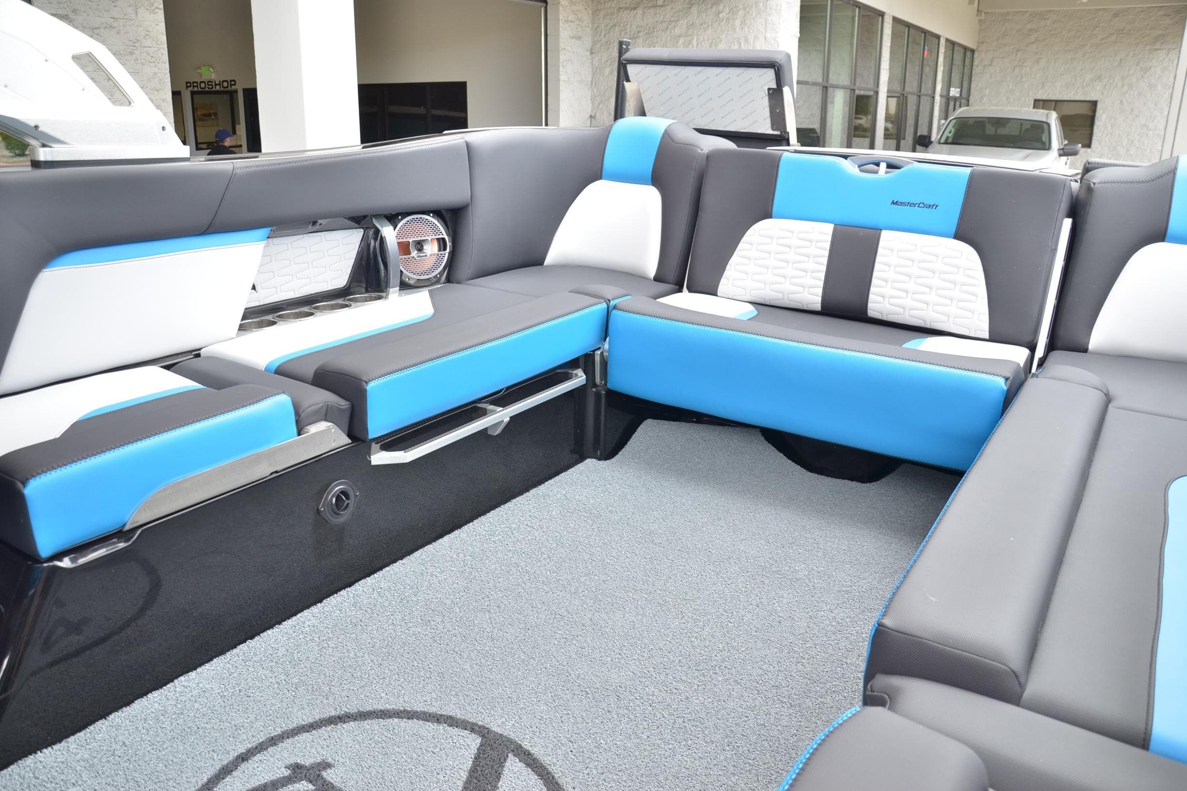 2020 MasterCraft X24 boat interior with blue and white seating, modern design.