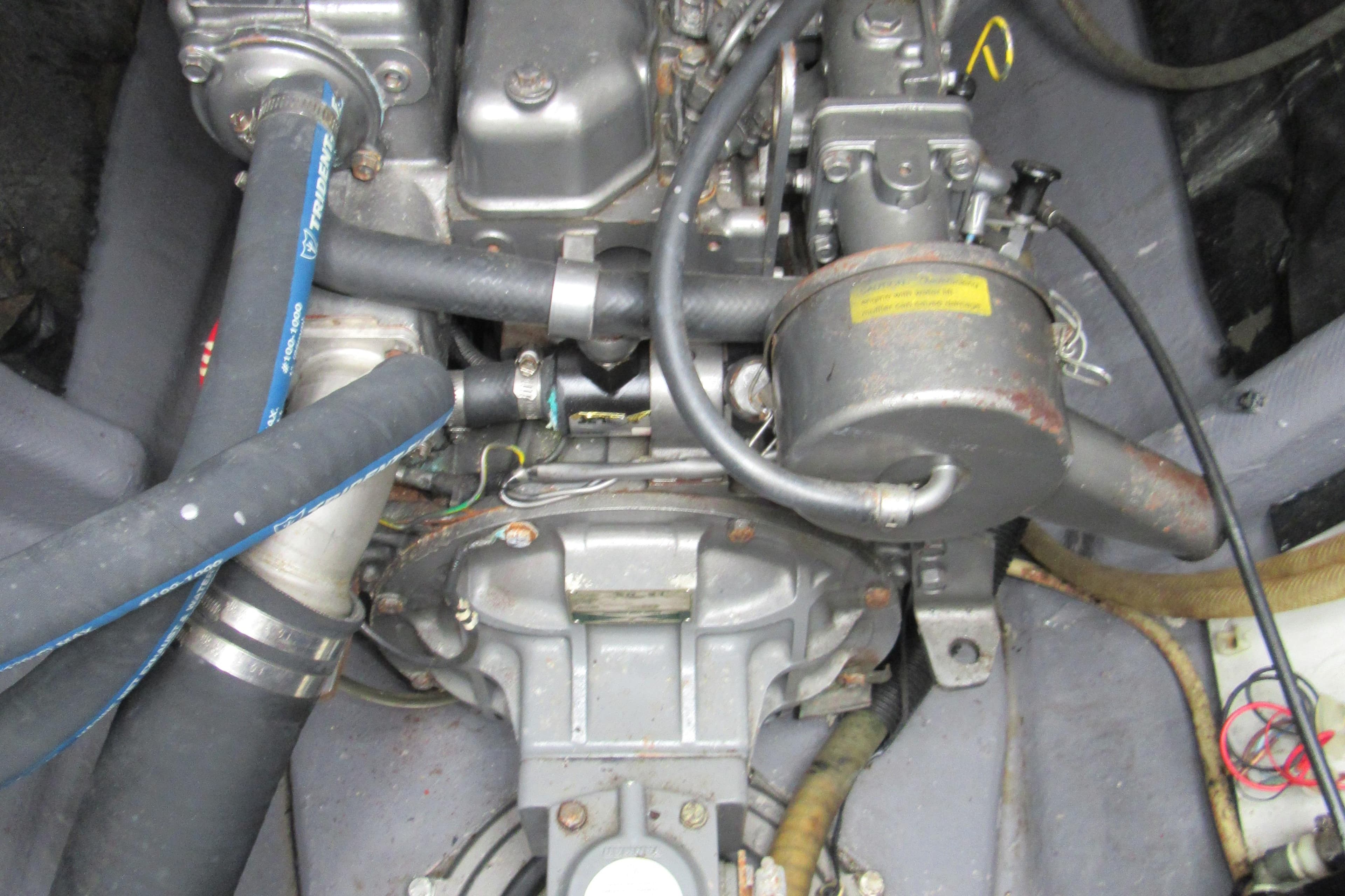 Engine compartment of a 2001 Catana 471, showcasing mechanical components and hoses.