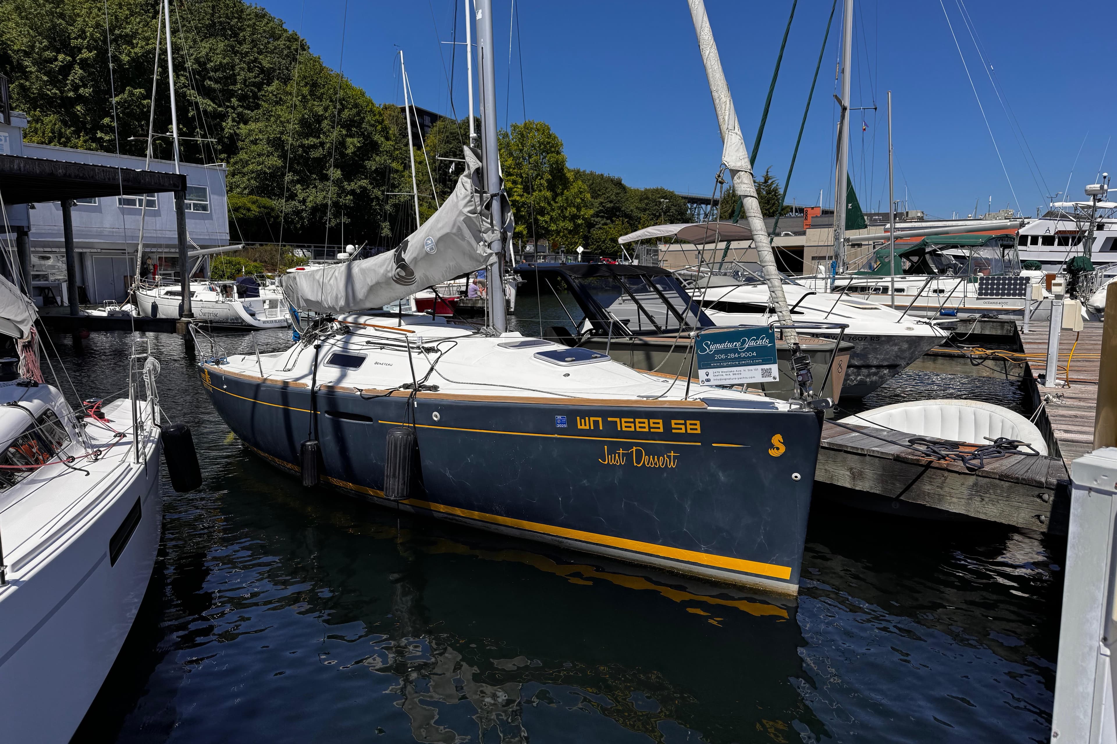 2014 Beneteau FIRST 25 S sailboat docked at marina, surrounded by other boats.