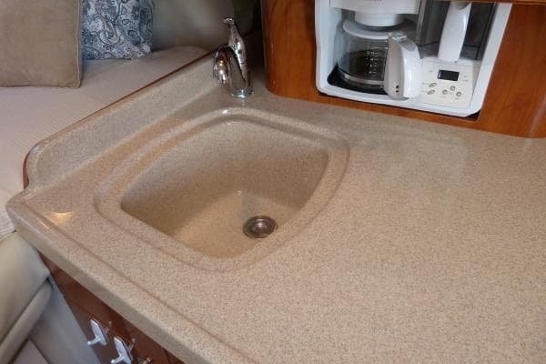 2004 Four Winns 298 Vista boat kitchen with sink and coffee maker.