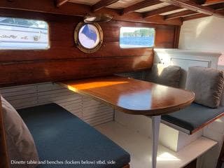 Interior of 1928 Historic Lake Union Drydock DREAMBOAT with dining table.