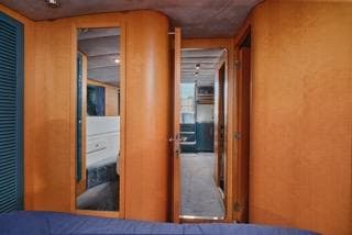 Interior of 1994 Riva RIVA 51 TURBOROSSO yacht, featuring wooden doors and cozy cabin space.