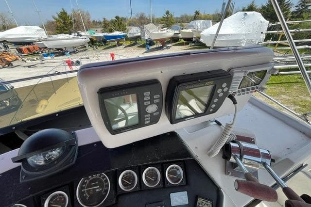 Control panel of a 1988 Trojan International 10 Meter Sedan boat with navigation instruments.