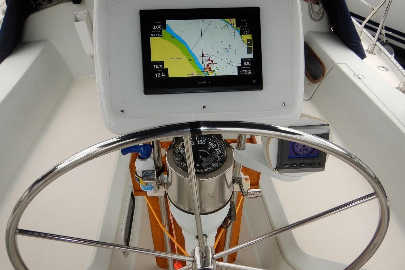 Steering wheel and navigation equipment on a 1989 Ericson 38 - 200 Masthead Sloop.