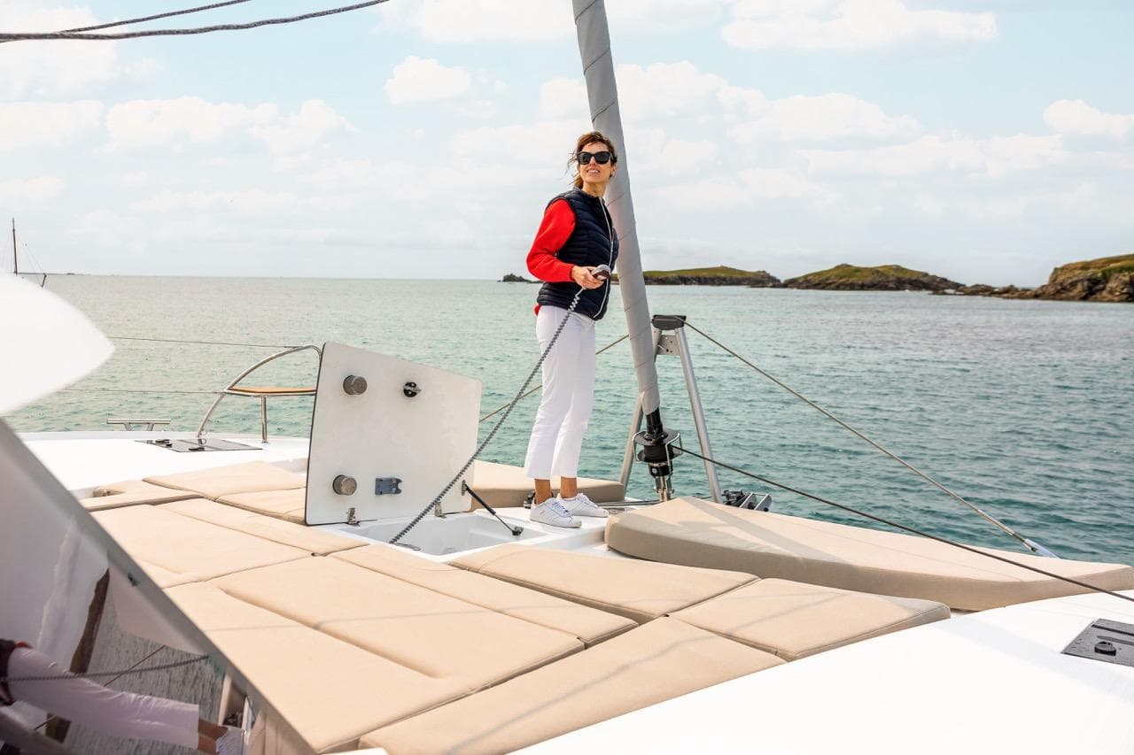 Woman enjoying sailing on 2026 Fountaine Pajot NEW 41 catamaran.