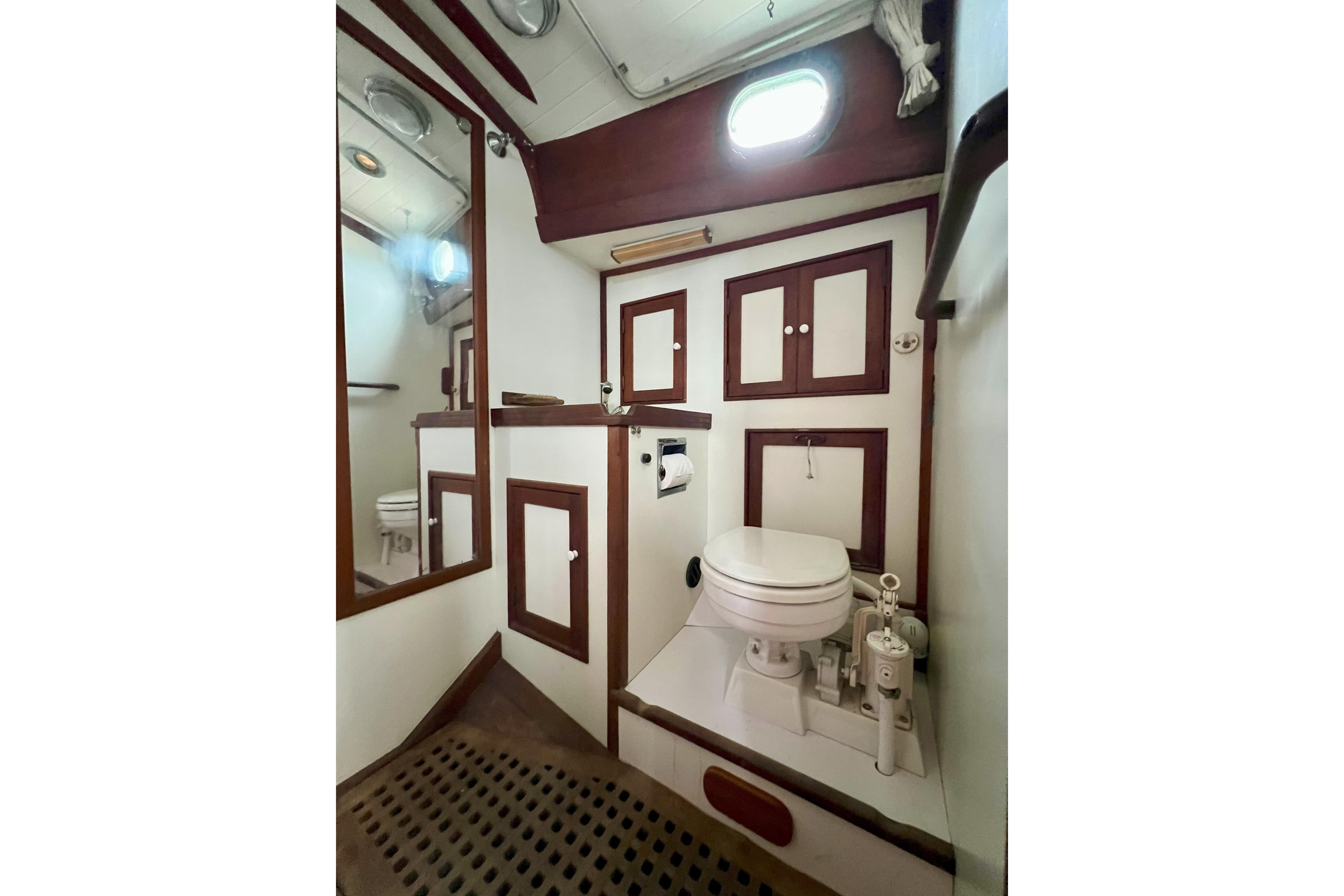1981 Shannon 38 Ketch bathroom with wooden accents and nautical design elements.