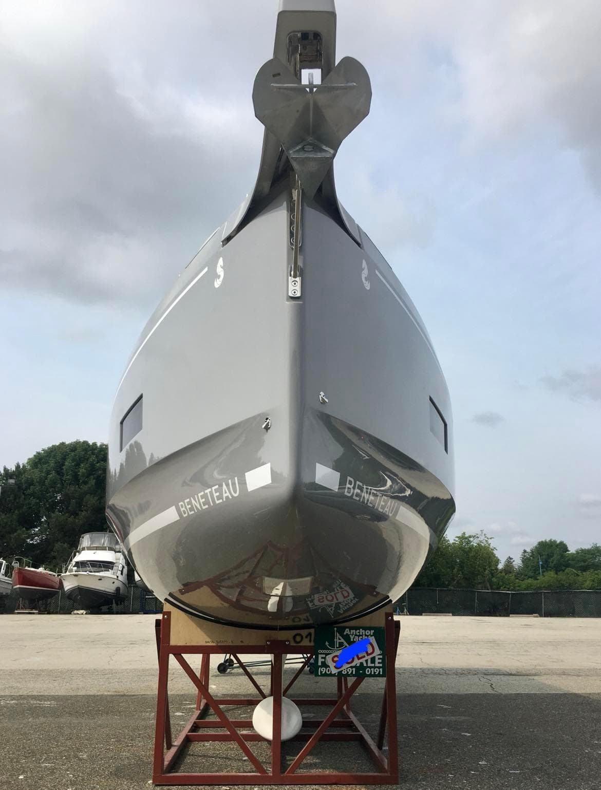 2025 Beneteau Oceanis 40.1 yacht on stand, front view, overcast sky.