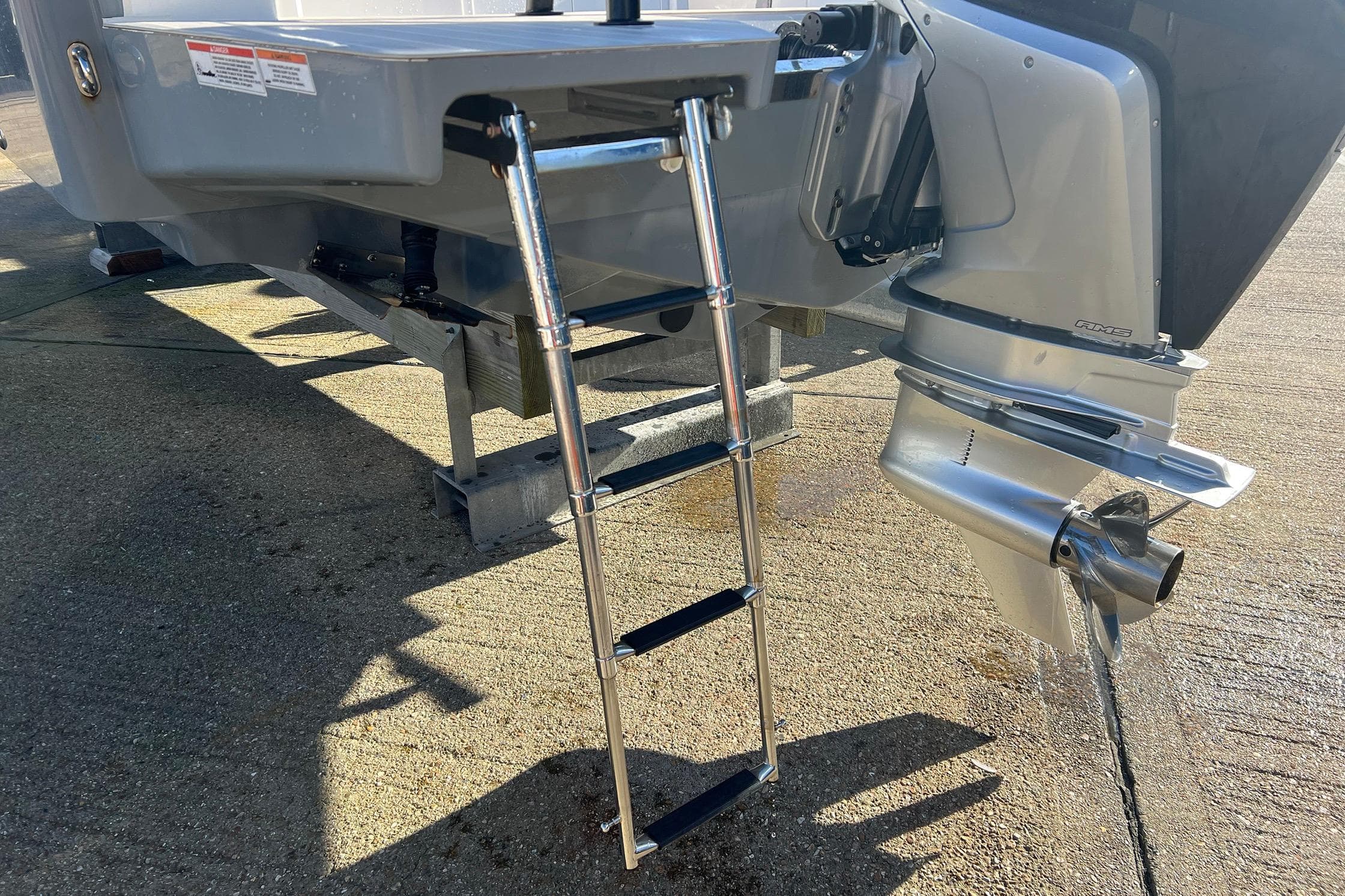 2019 Axopar 28 T-Top boat with ladder and outboard motor on dry dock.