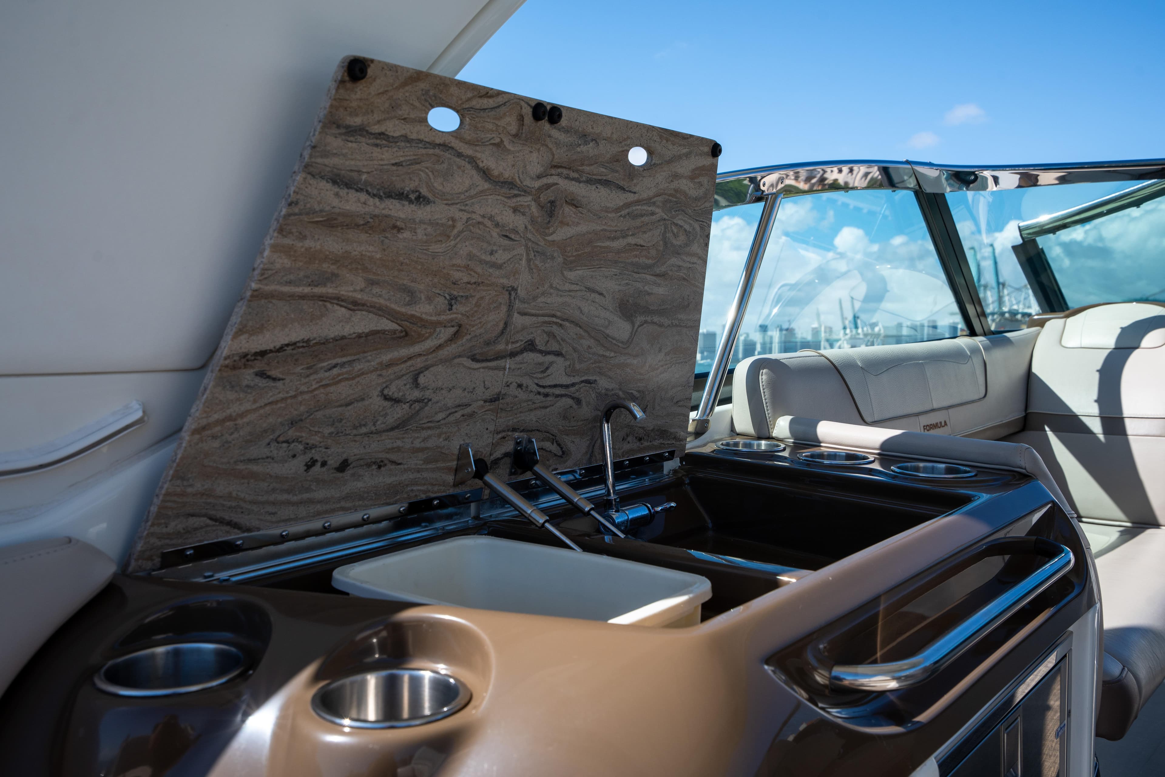2018 Formula 350 Crossover Bowrider OB boat interior with sink and seating area.