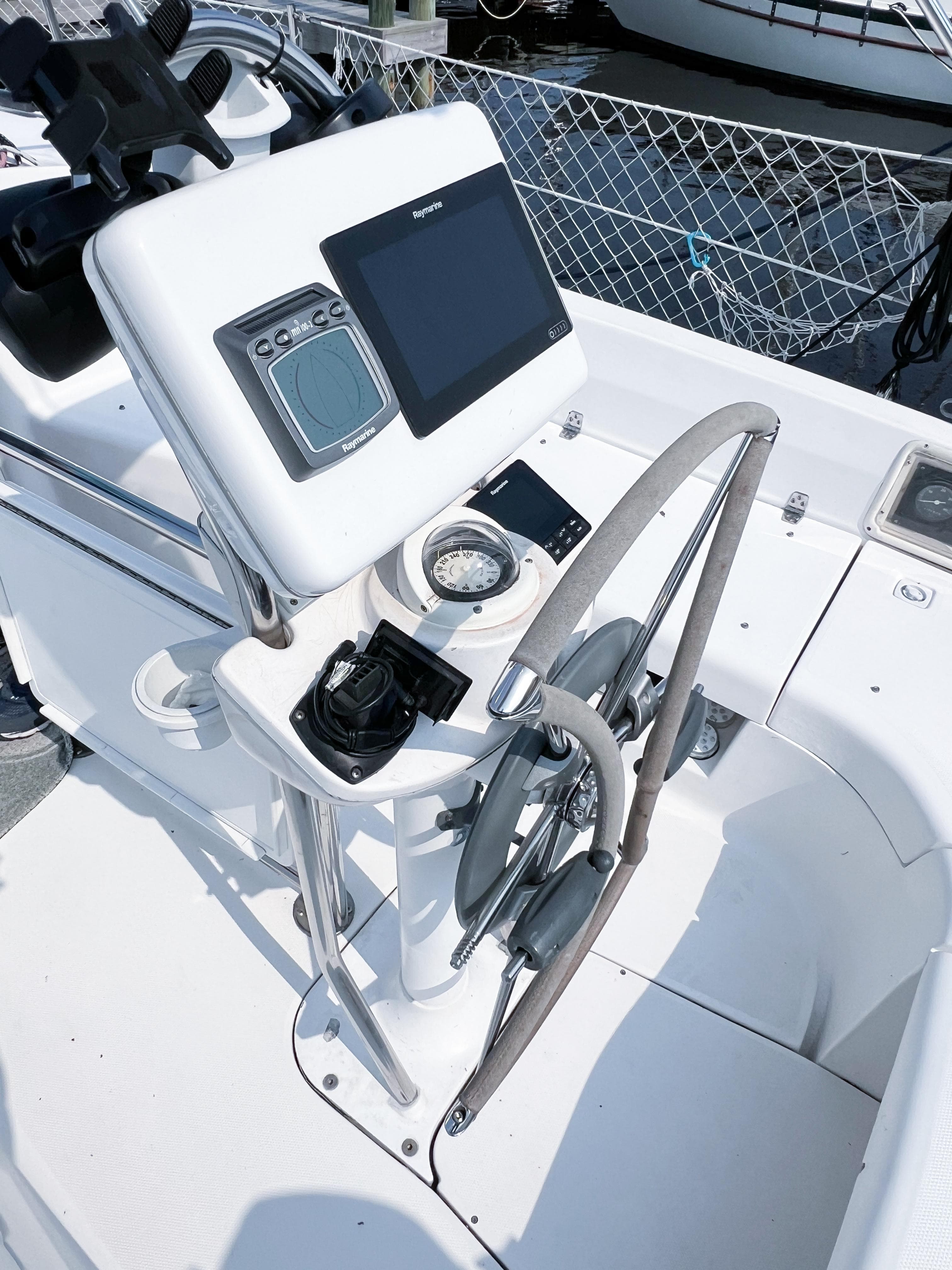 Steering console of a 2002 Hunter 356 sailboat with navigation equipment.