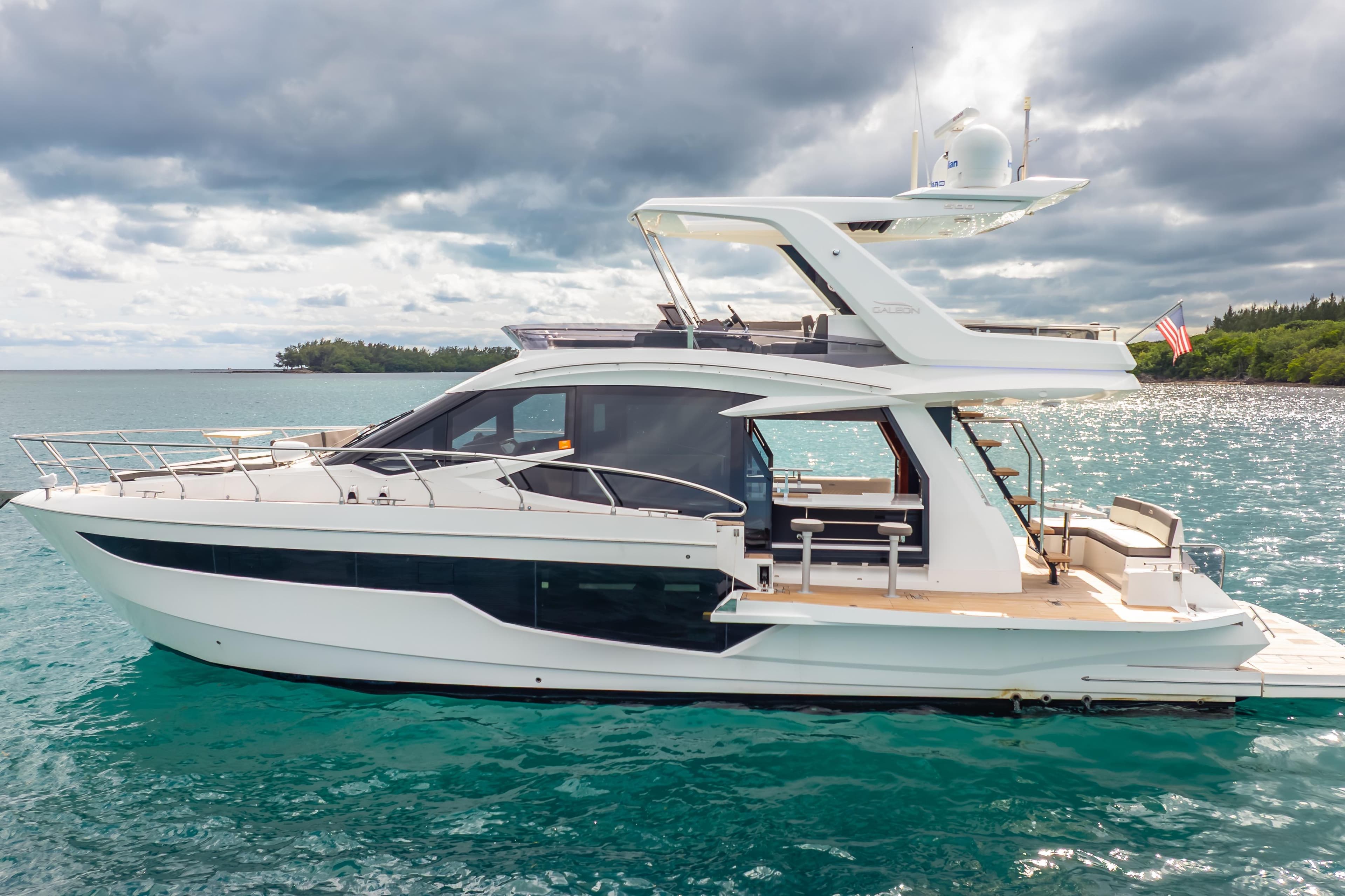 2020 Galeon 500 Fly yacht on turquoise water under cloudy sky.