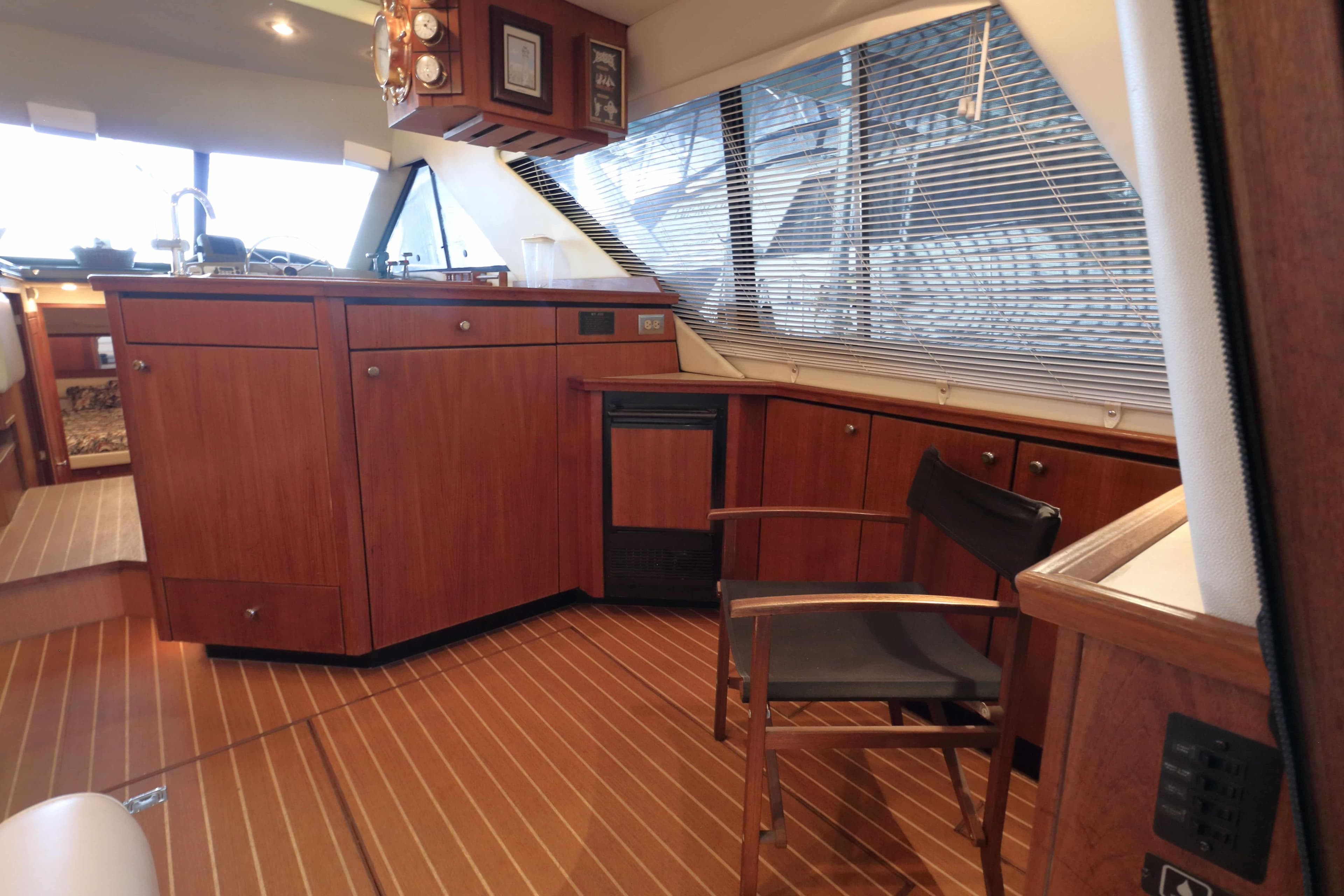 Interior of 1995 Bayliner 3988 Command Bridge Motoryacht with wooden cabinetry and seating.